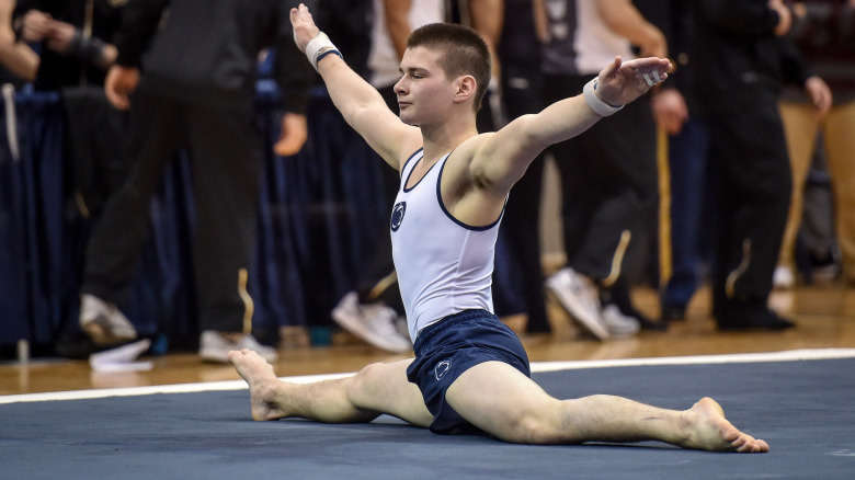 Male gymnast does split on floor