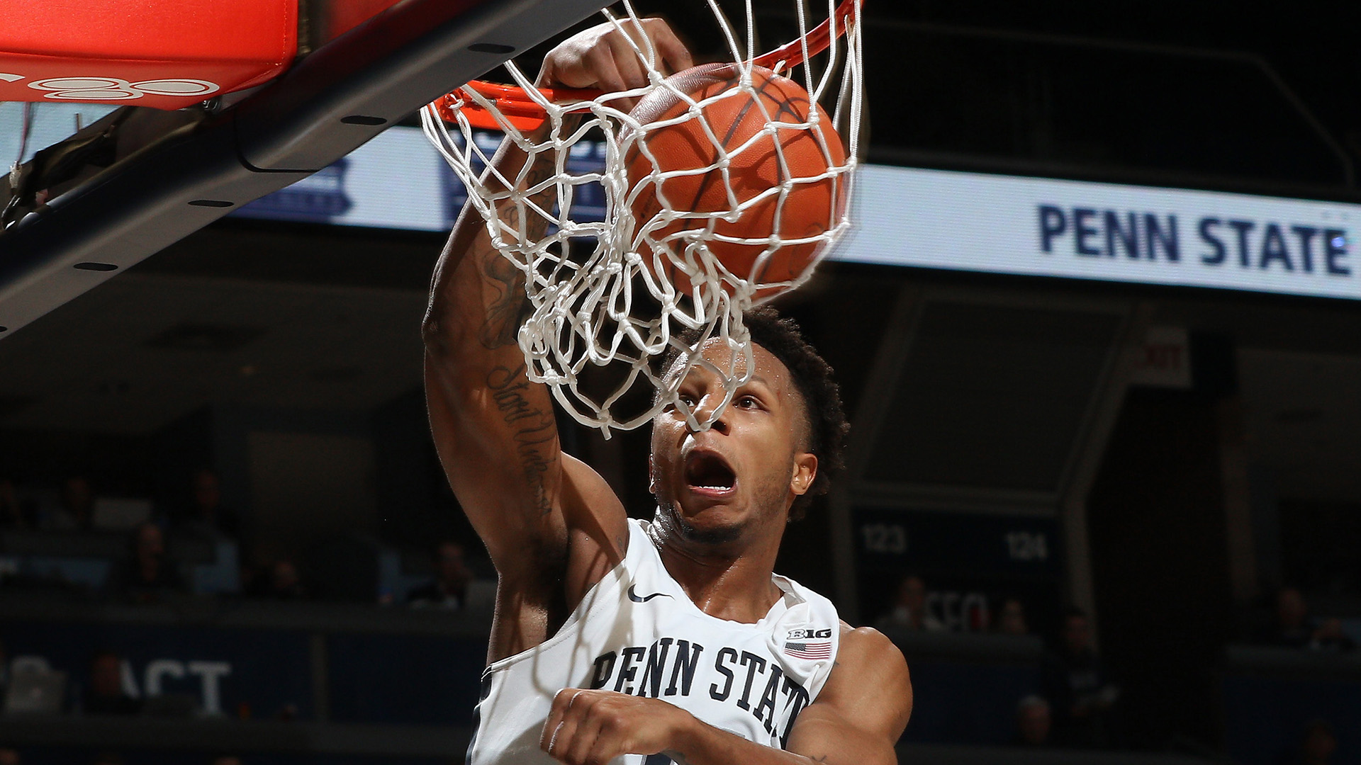 man dunking basketball