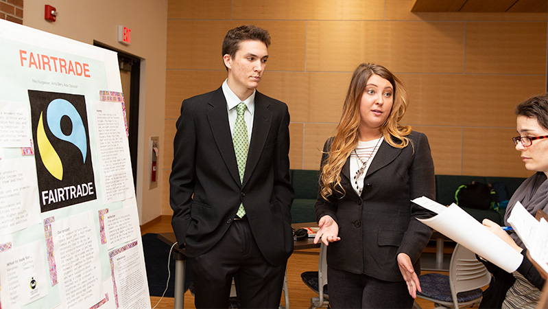 Two students present their project to judges.