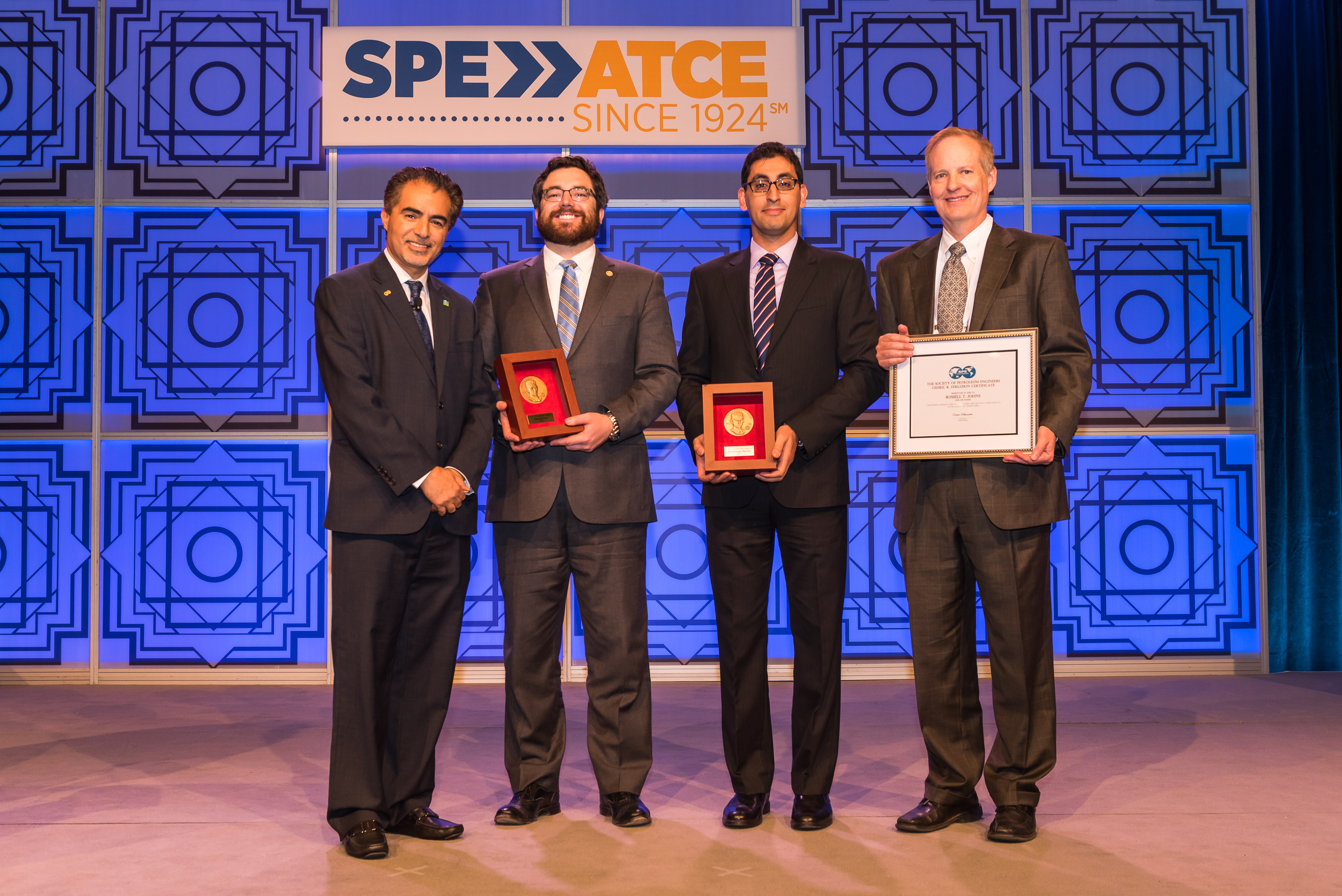 Society of Petroleum Engineers (SPE) President, Sami Alnuaim, presents Penn State researchers Michael Cronin, Hamid Emami-Meybodi and Russ Johns with Cedric K. Feguson Medals and Certificate.