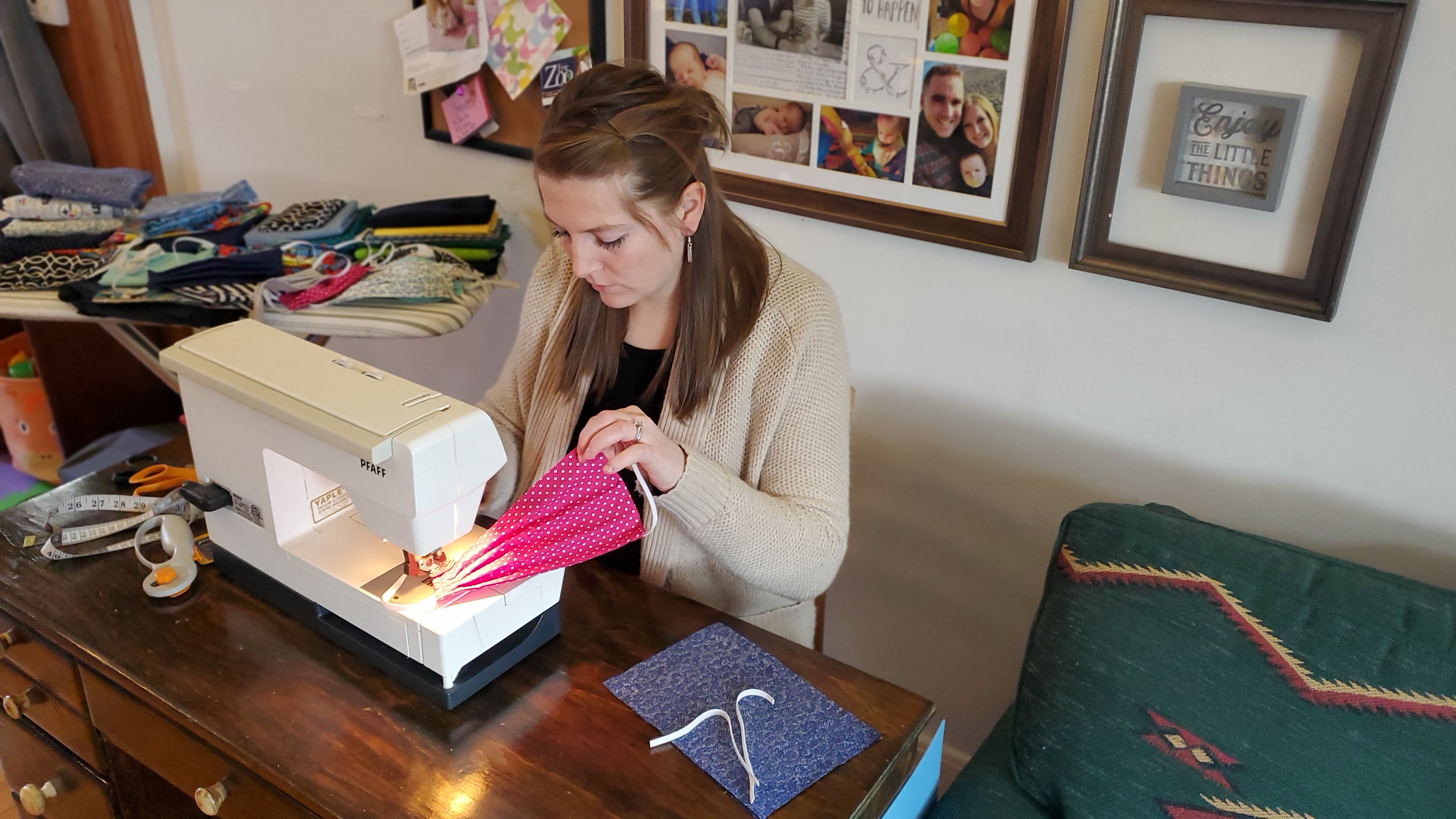 Torie Shapter sewing masks at sewing machine. 