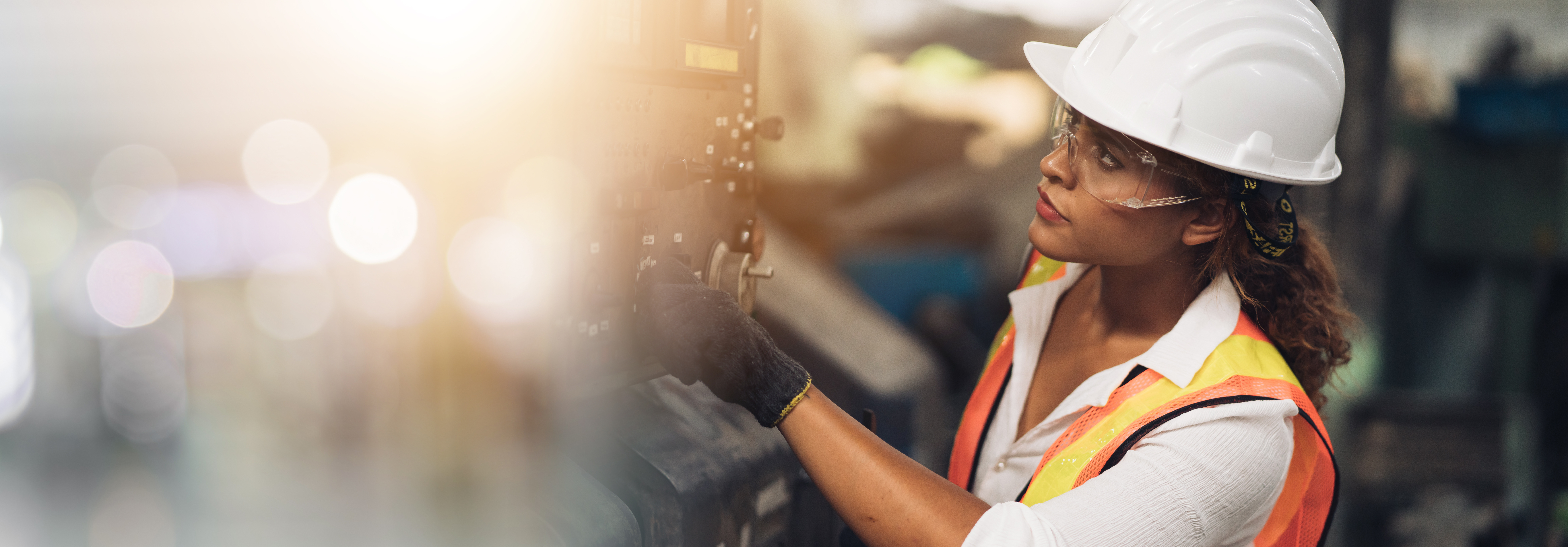 Woman wearing hard hat on shop floor