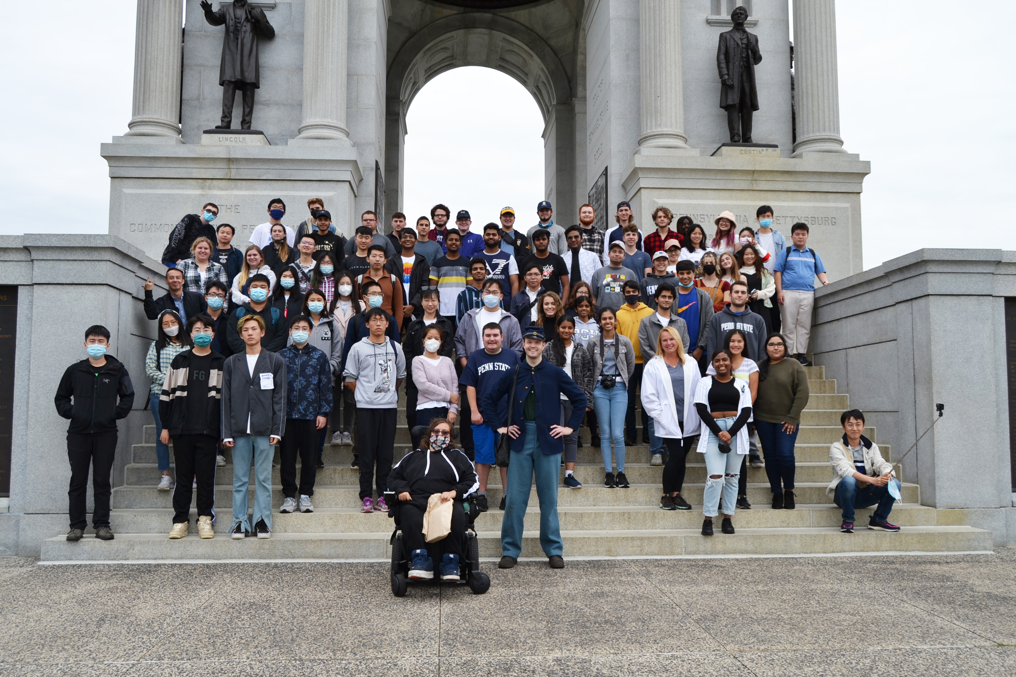 A large group of students standing on steps in front of the Pennsylvania Memorial