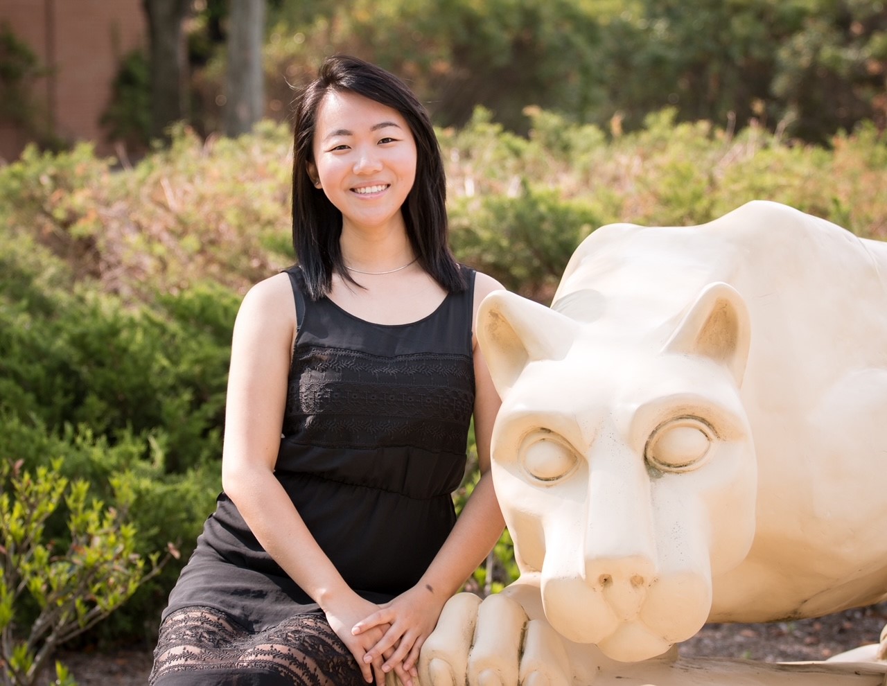 A woman posing in front of the Lion Shrine