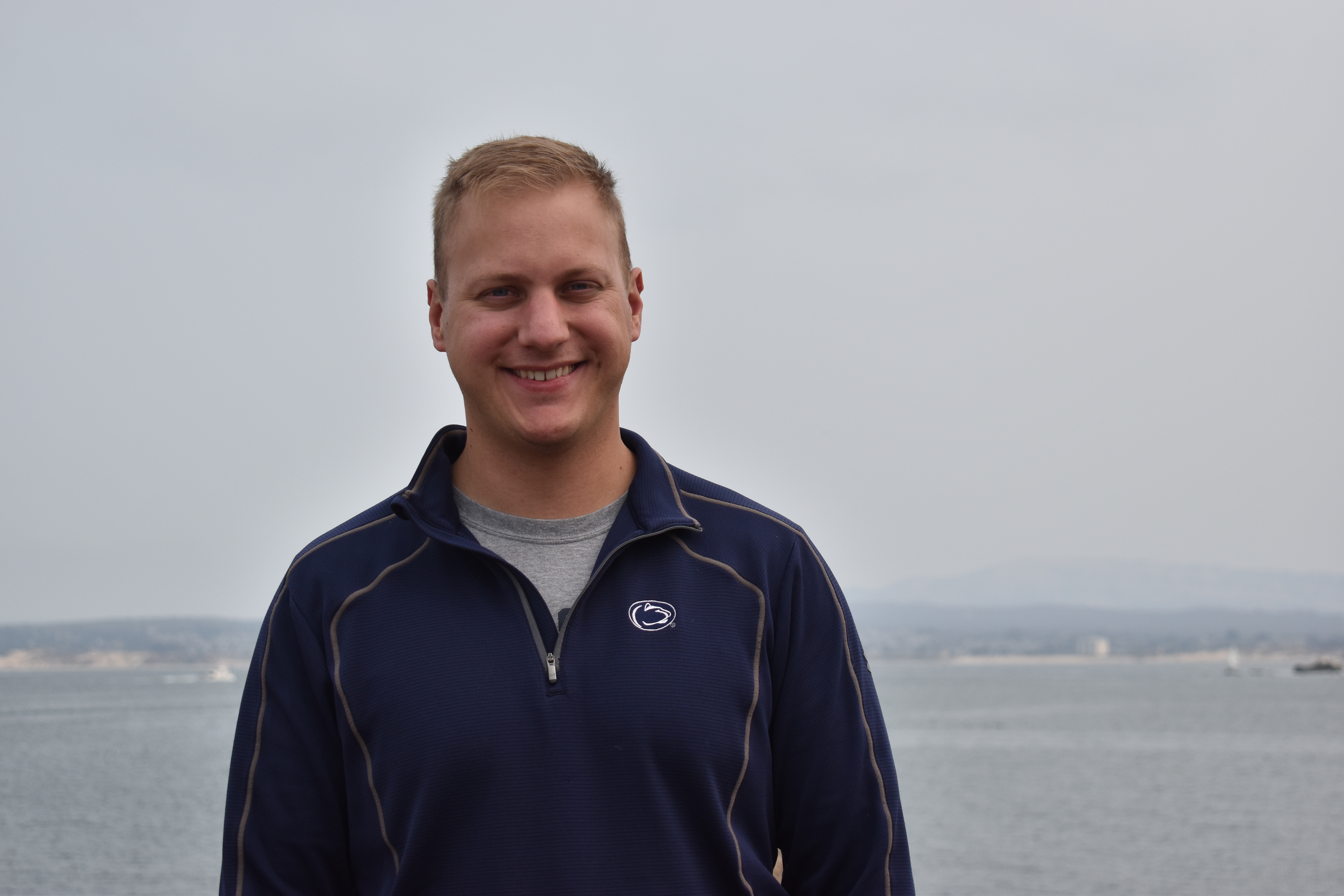 John McFarland stands in front of ocean