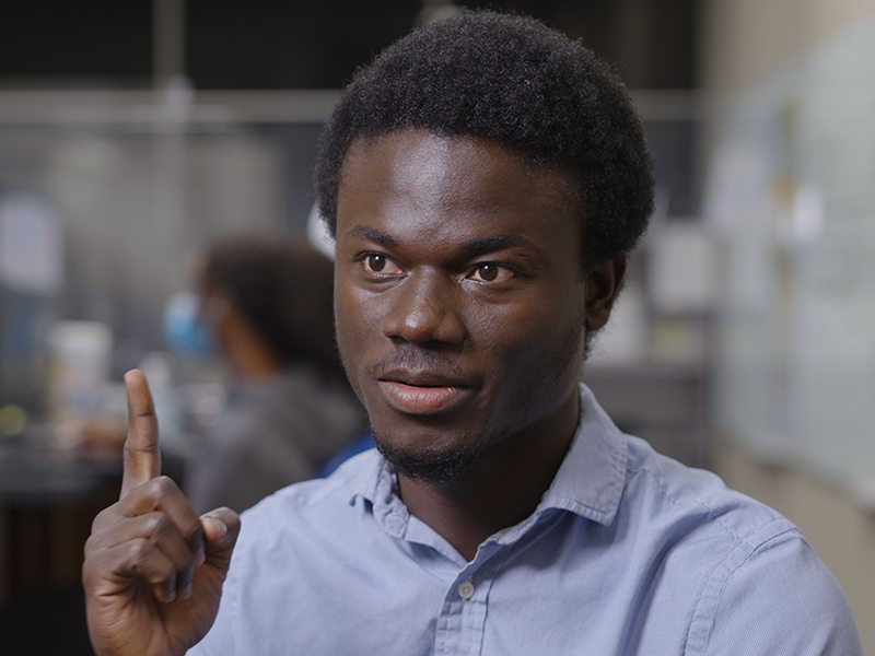 Edward Amoah sitting on a stool while being interviewed