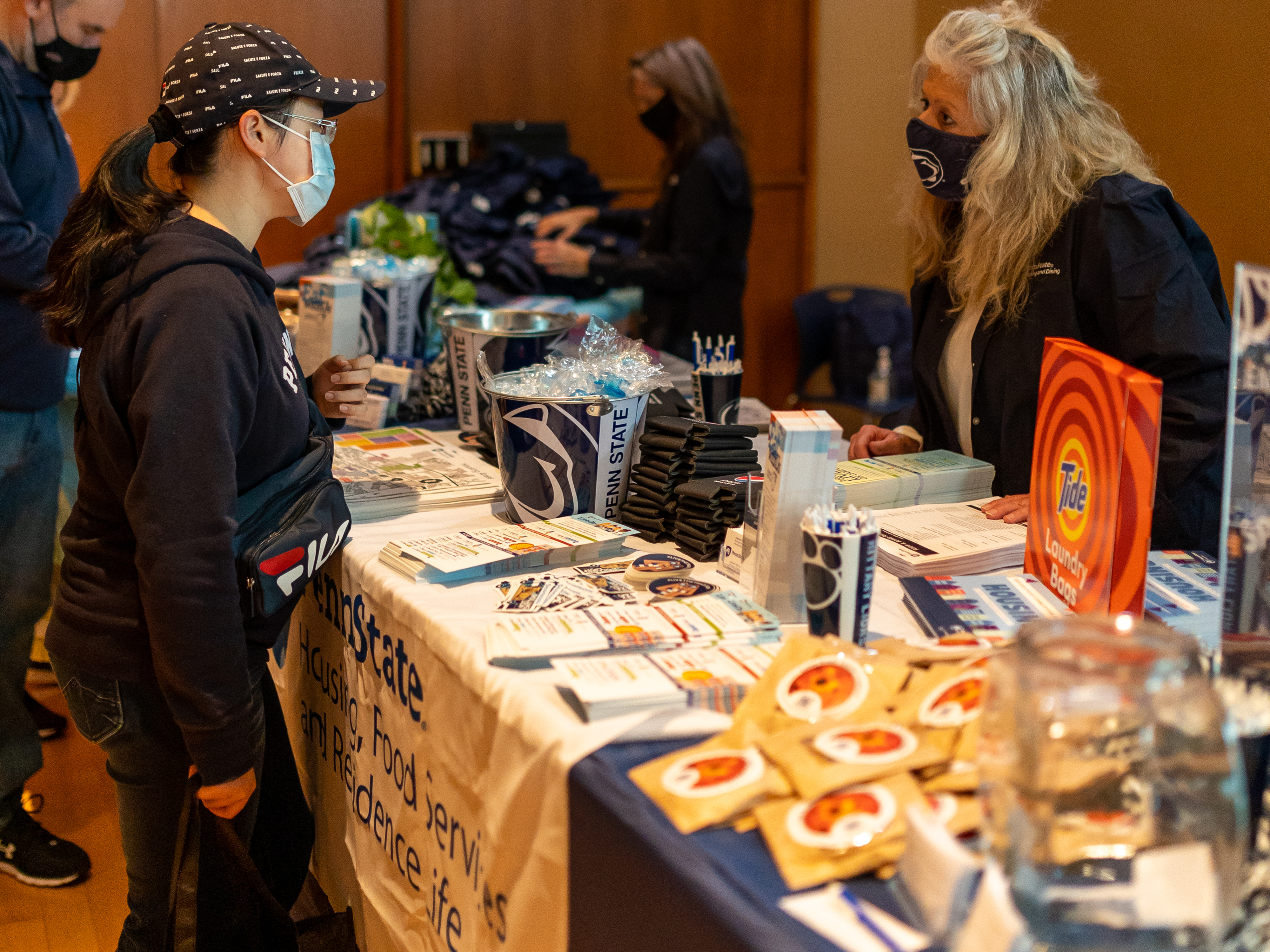 Student talking to a vendor at the housing fair