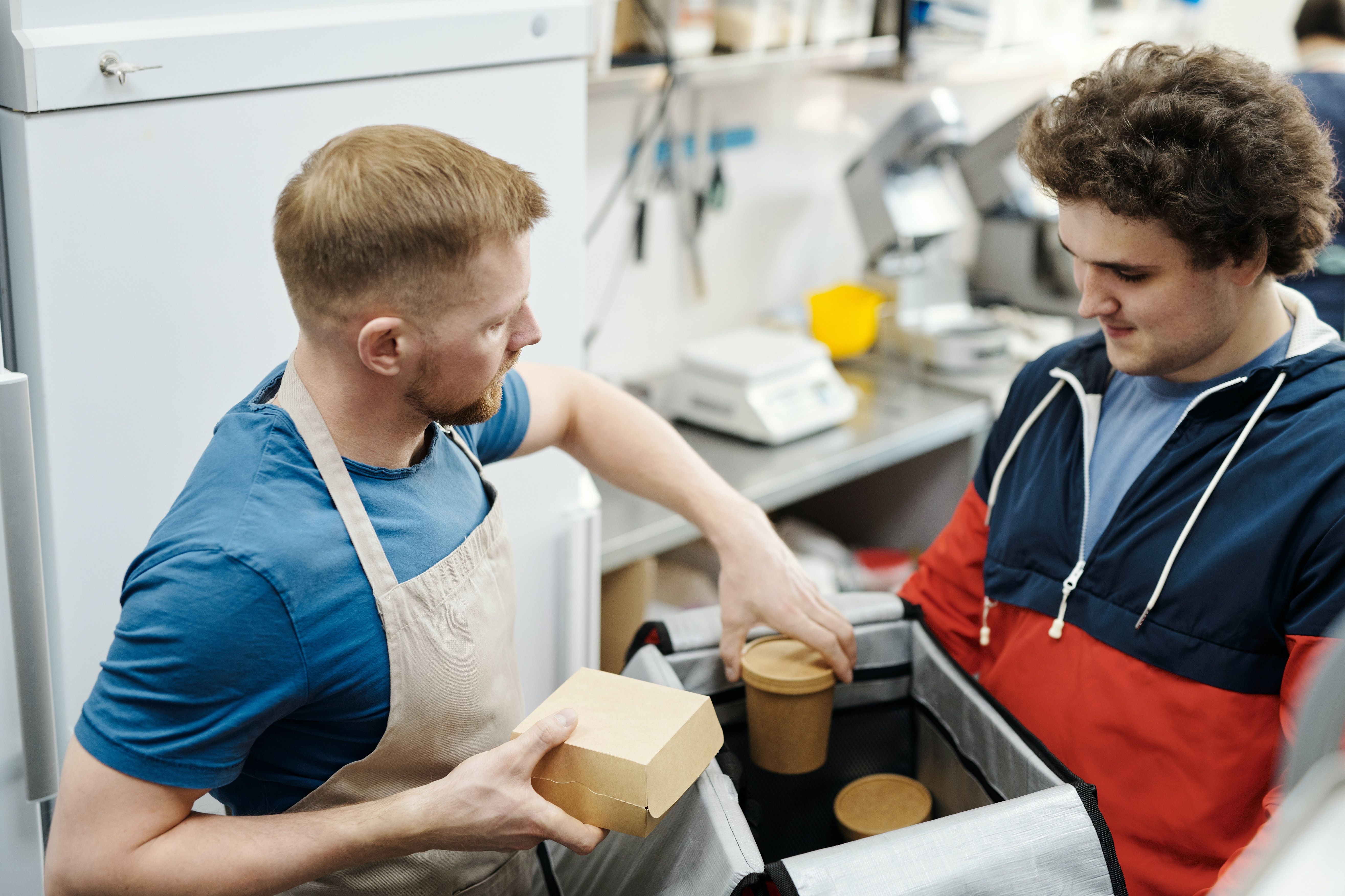 Food service staff pack food for delivery to customer