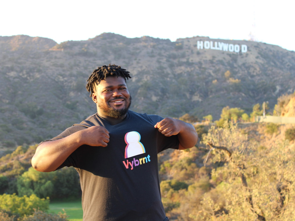 Founder Joel Sakyi standing with Hollywood sign