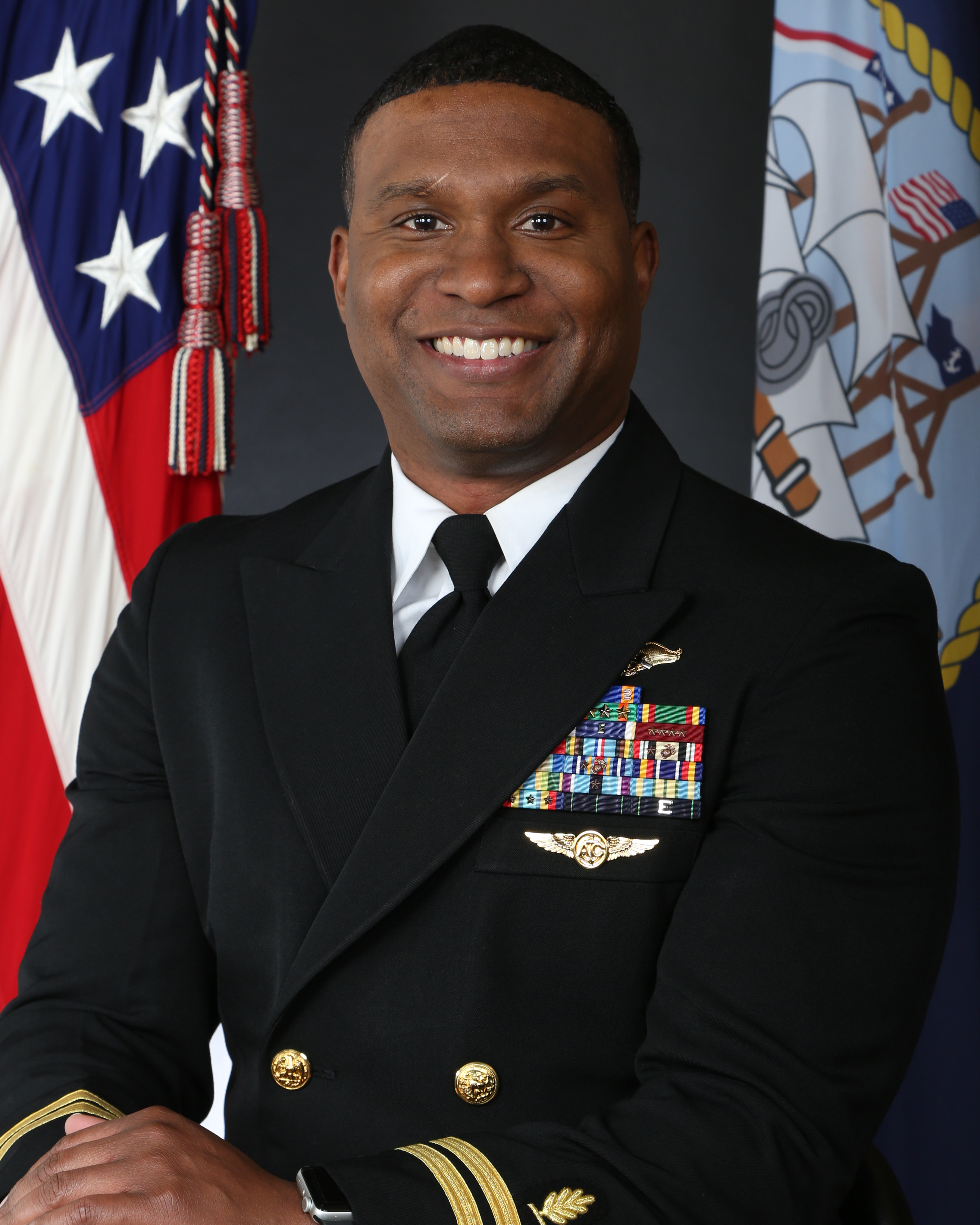 Kevin Hunt in military service dress uniform in front of american flag