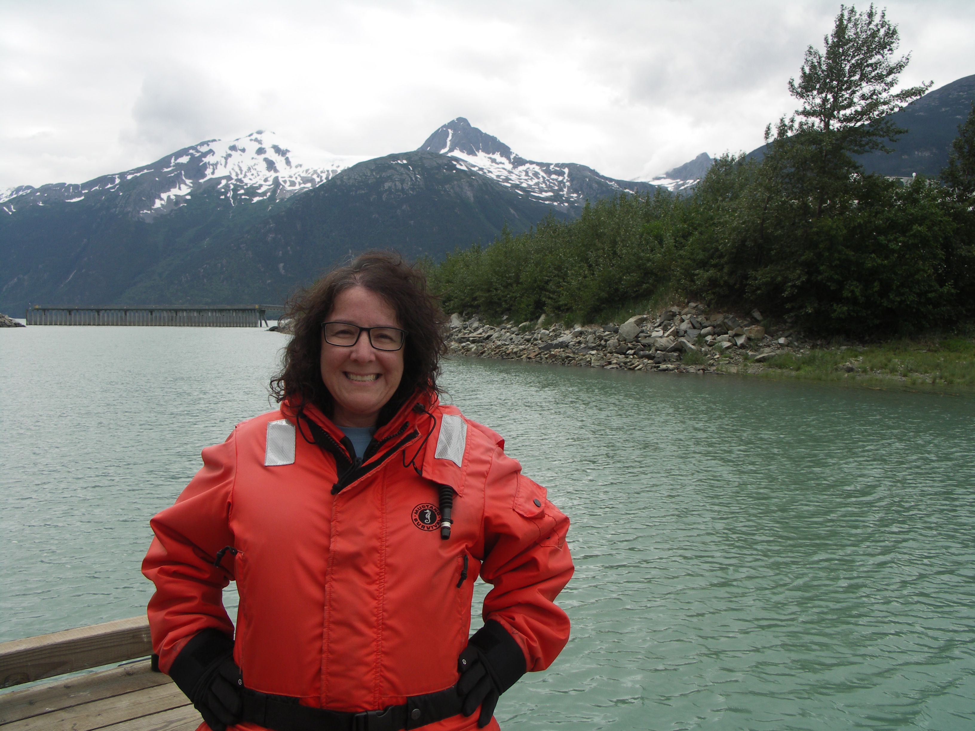 Professor Laura Guertin standing on the deck of a ship at sea.