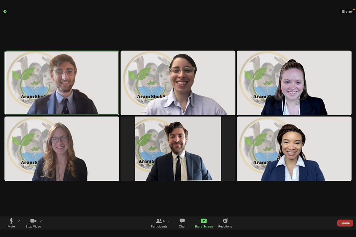 A screenshot of a Zoom meeting with six Penn State students, all wearing professional attire, smiling.