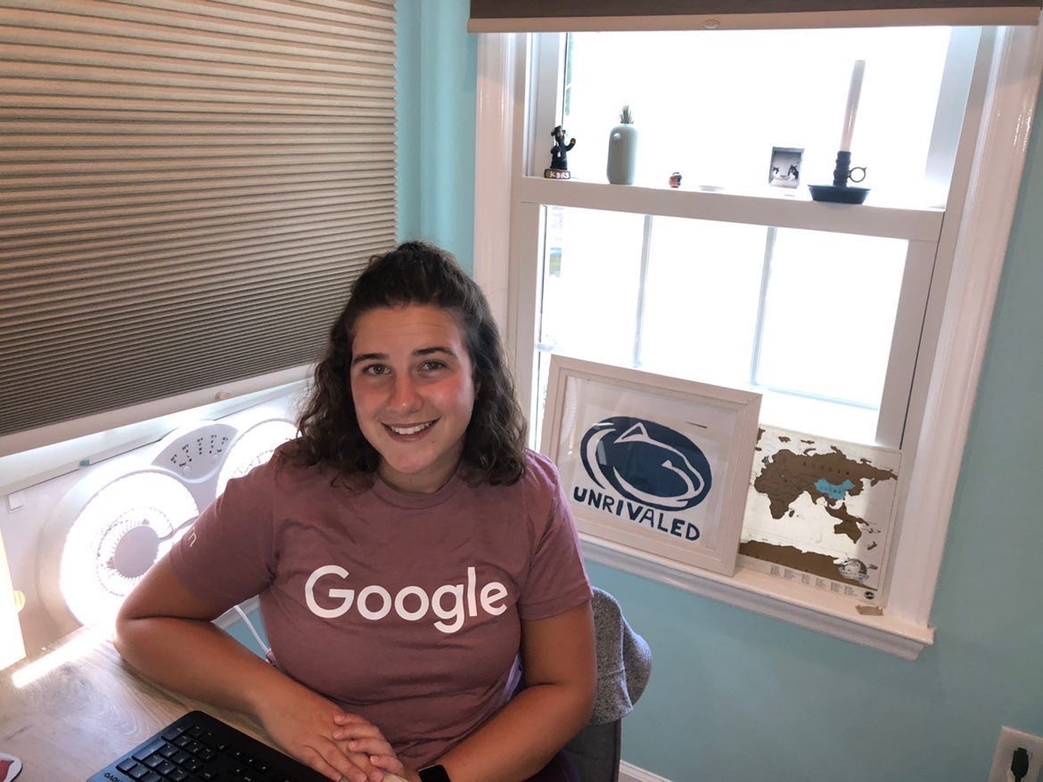 Kathryn Frankenberg wears a Google t-shirt in front of a Penn State "Unrivaled" sign