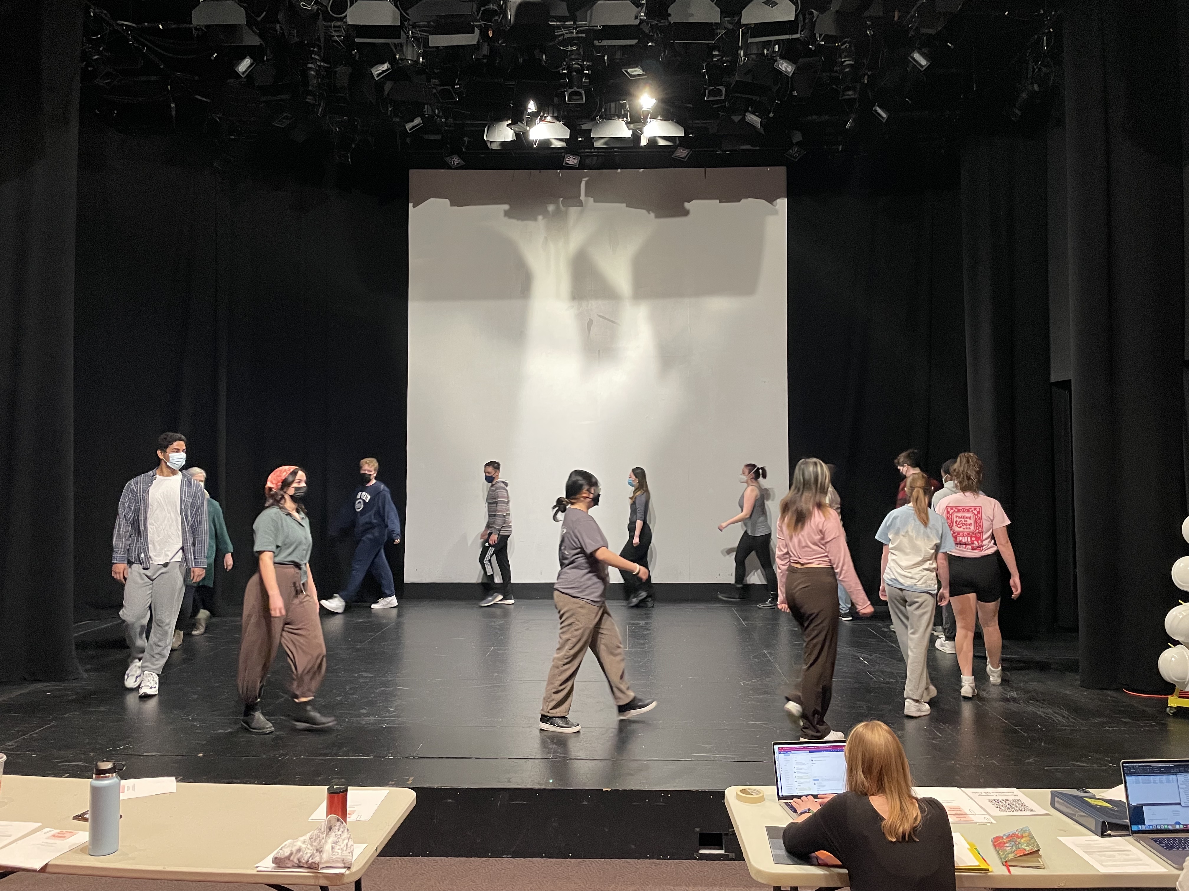 Masked students rehearsing a play