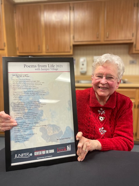 Rev. BJ Potter holding her poem 