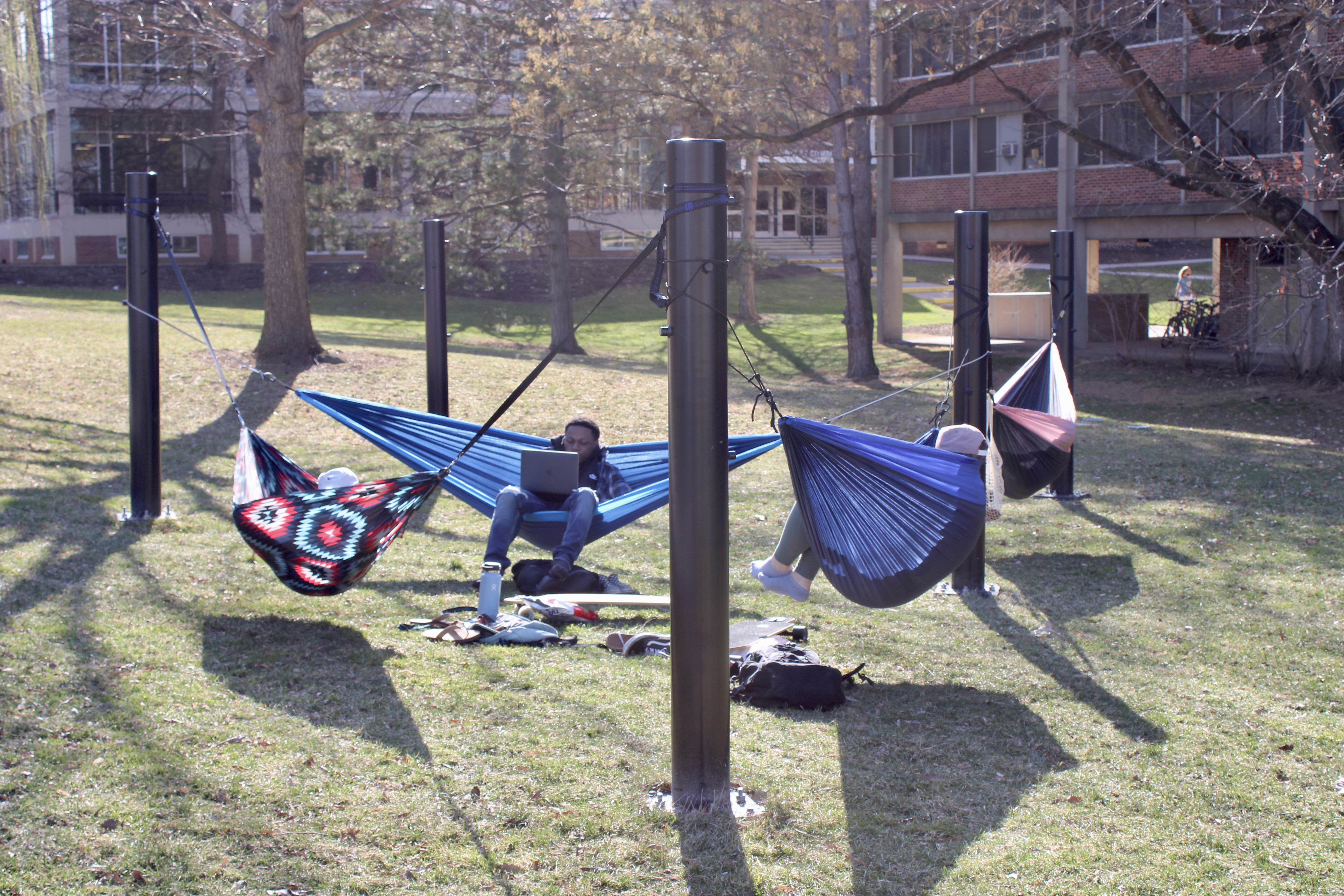 Students sitting on hammocks at the Hammock Grove.