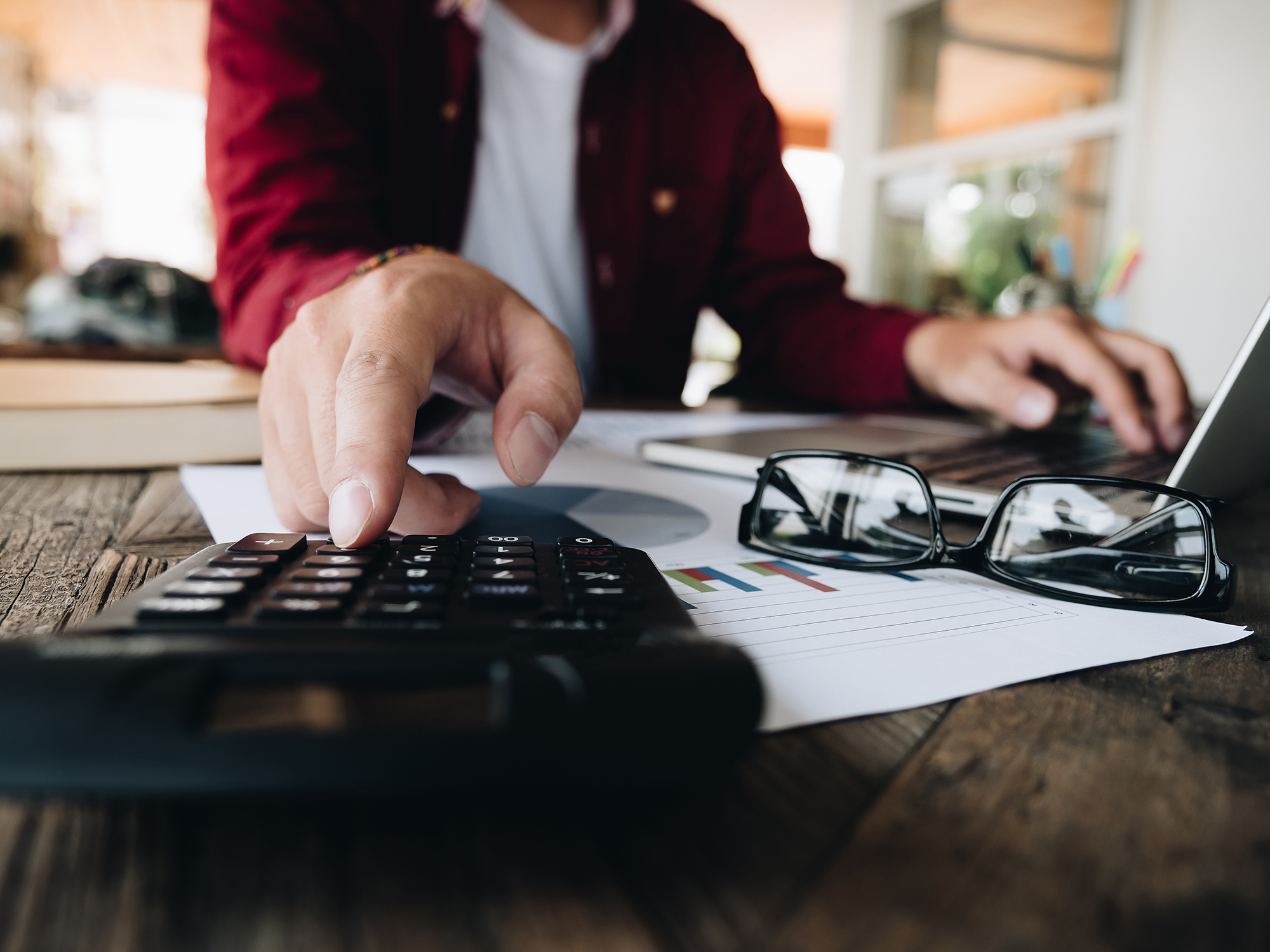 Close up view of bookkeeper or financial inspector hands making report, calculating or checking balance.