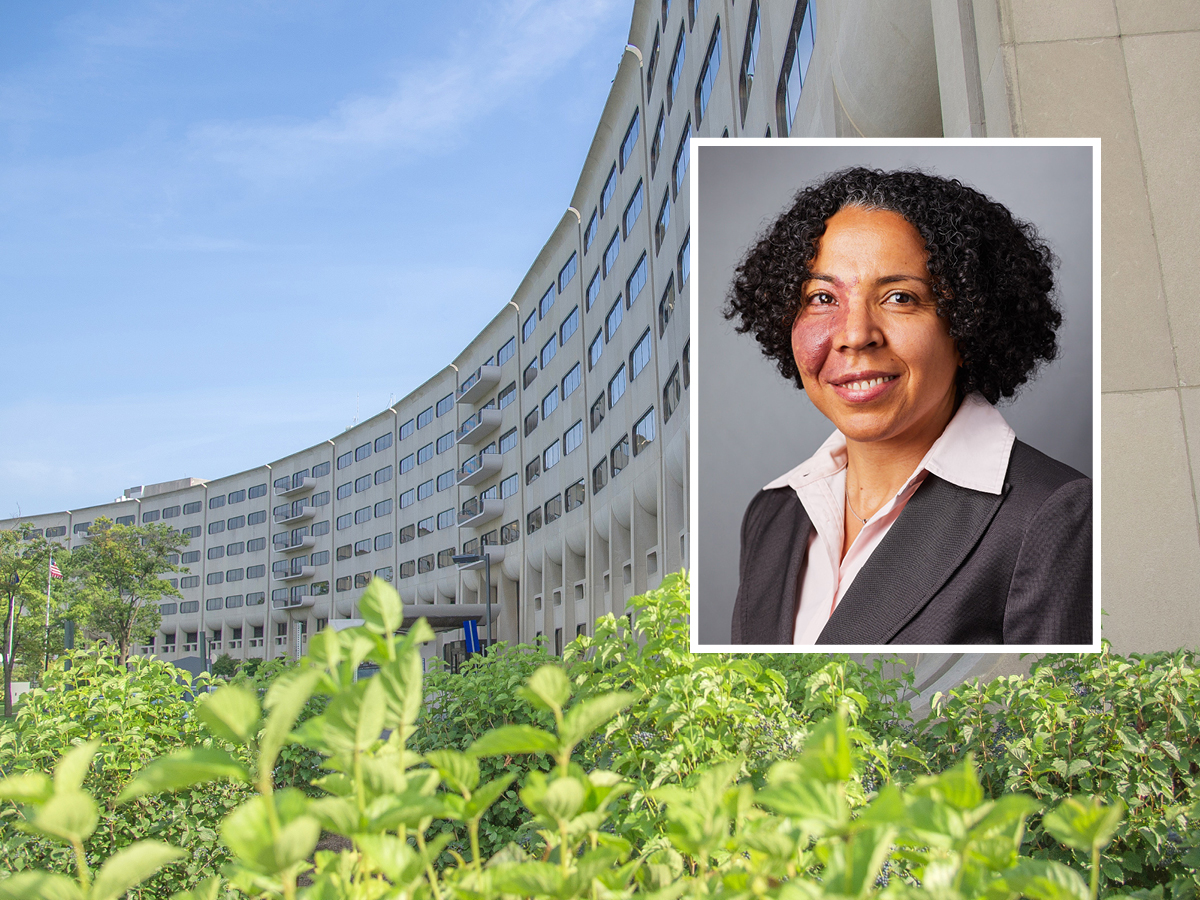 A head and shoulders professional portrait of Dr. Inginia Genao against a background image of Penn State College of Medicine. 