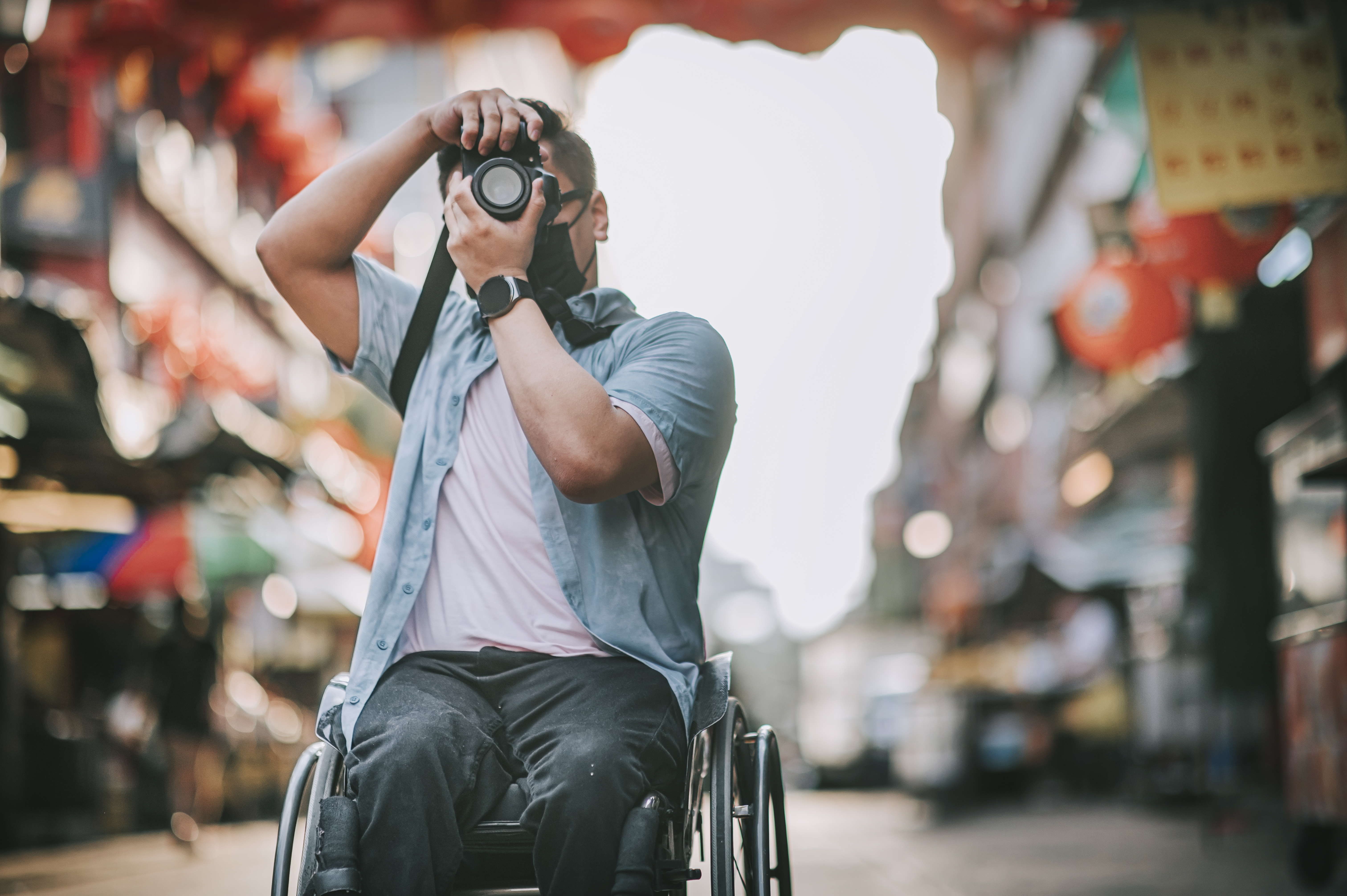 Man in wheelchair taking a photograph