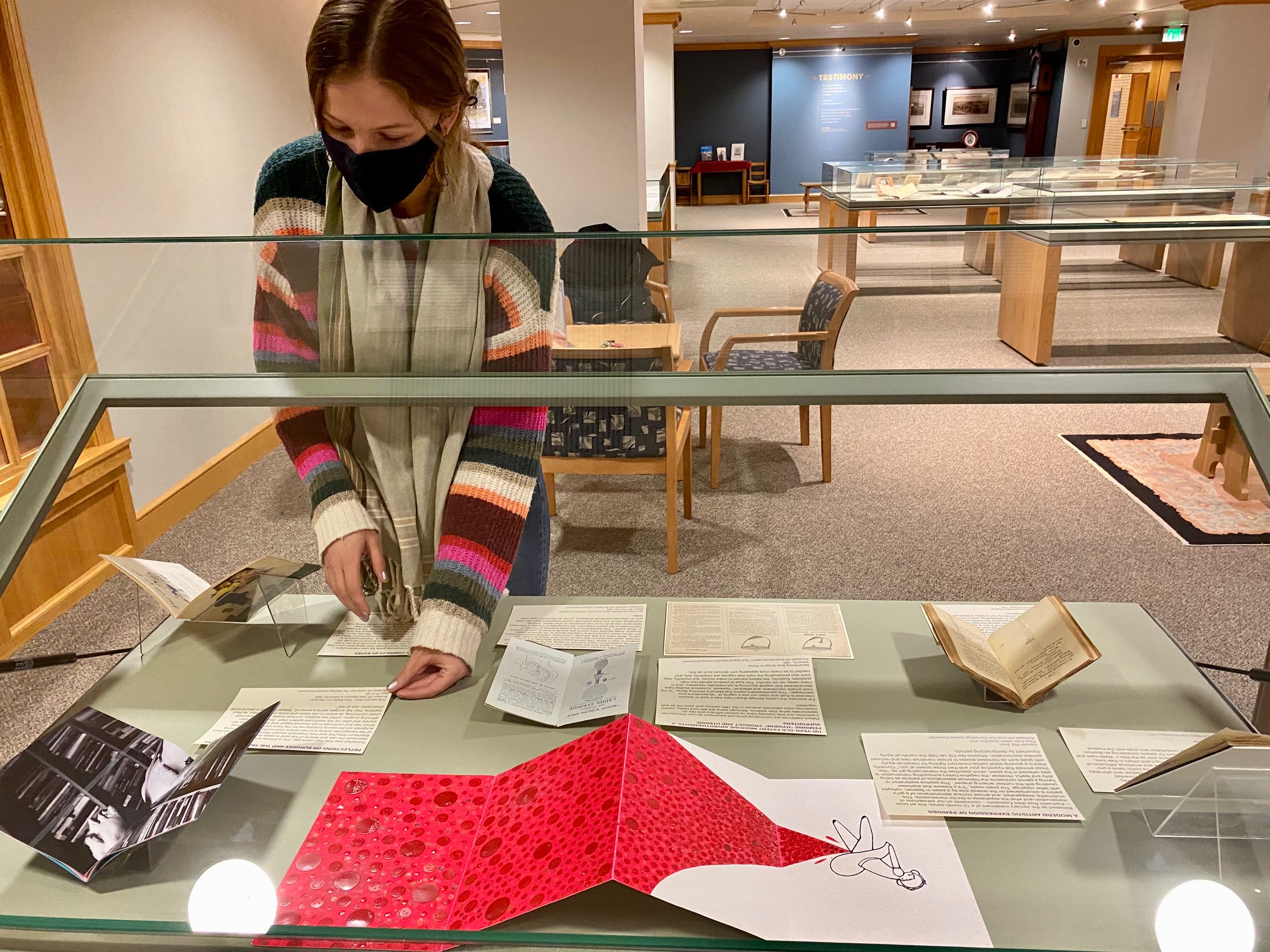 Grace Lemke arranging artifacts for her upcoming student-curated exhibition