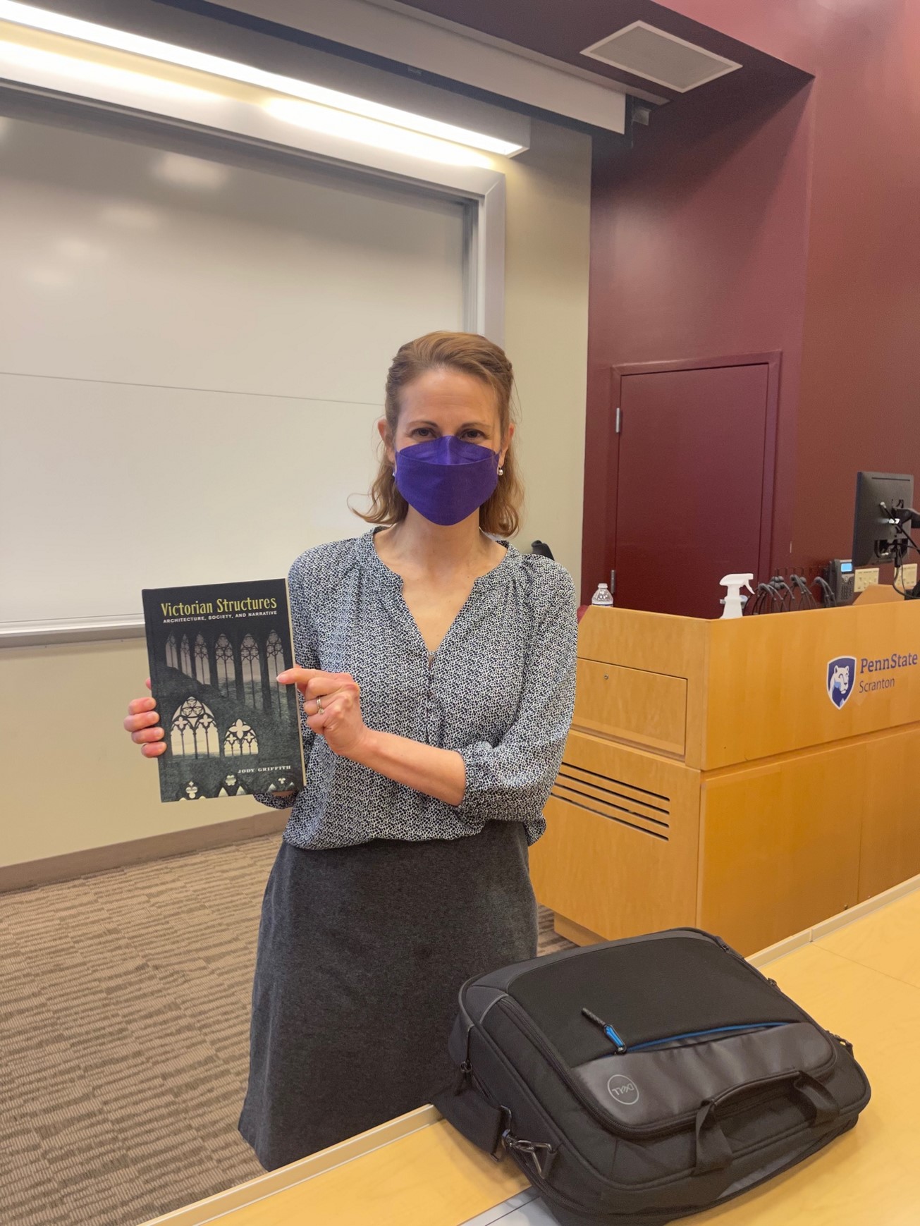 Jody Griffith holds up a copy of her first book, Victorian Structures