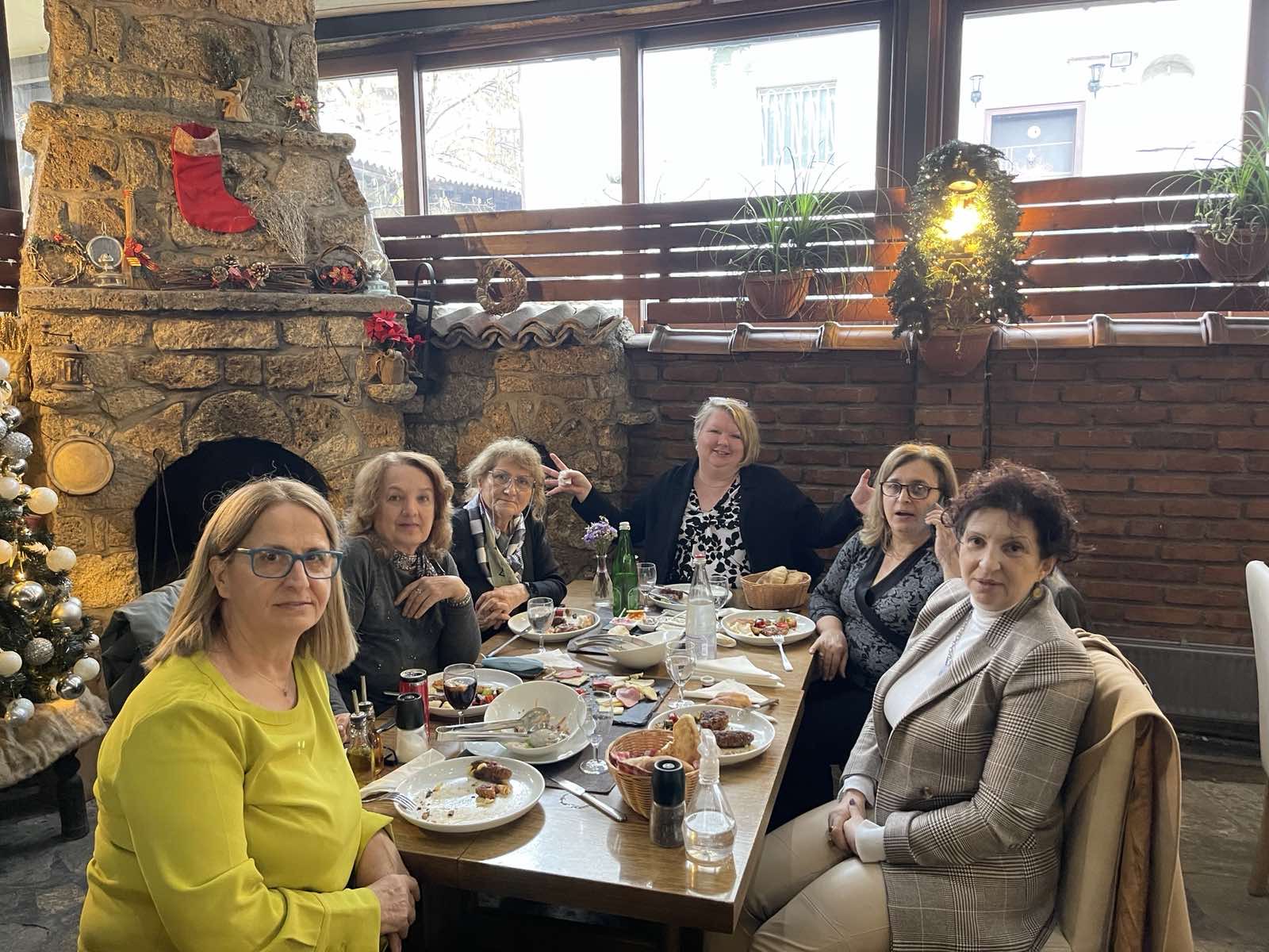 Photo of a group of people seated around table