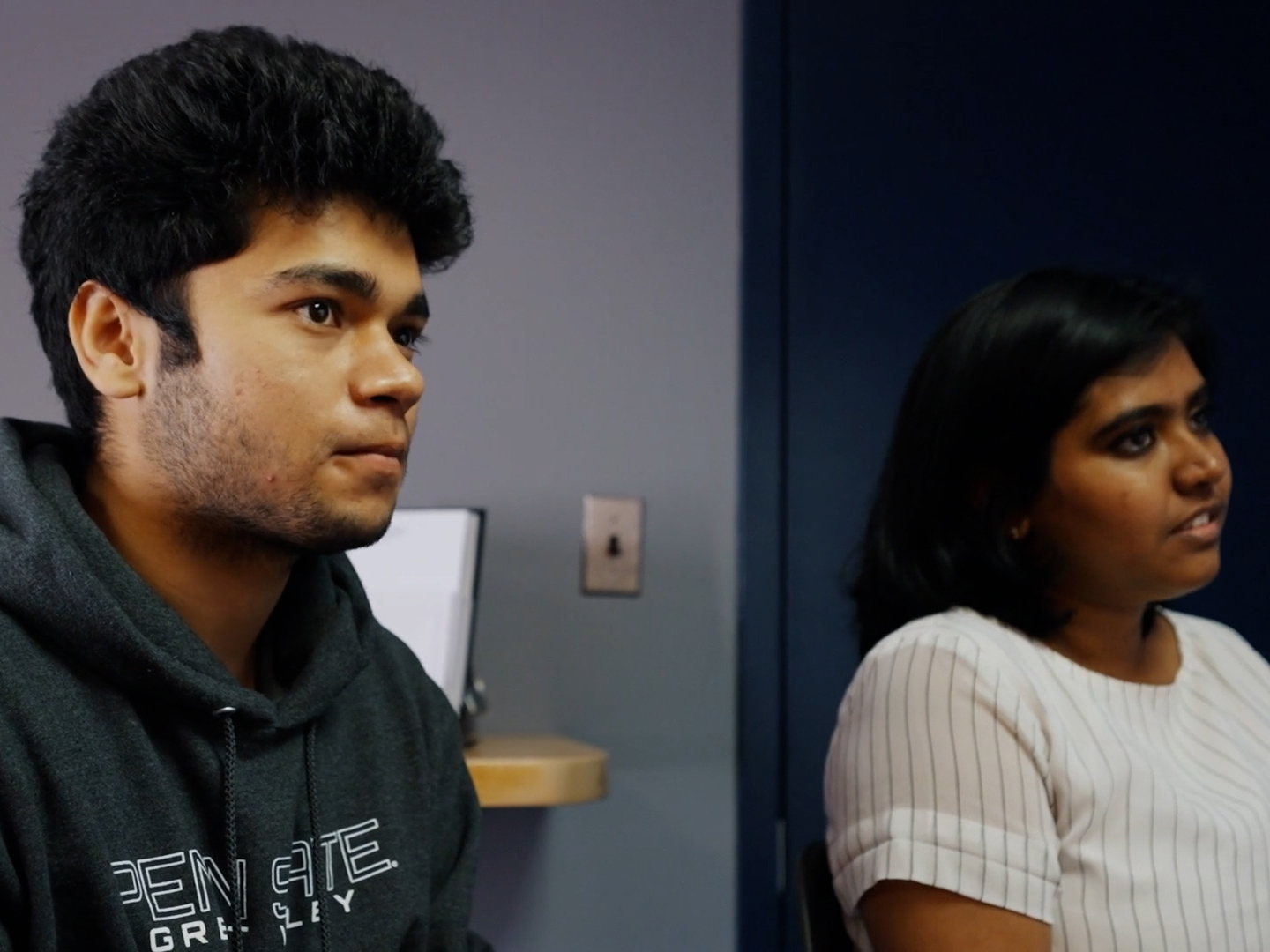 Nimisha Benoy and Utkarsh Singh sit in a classroom