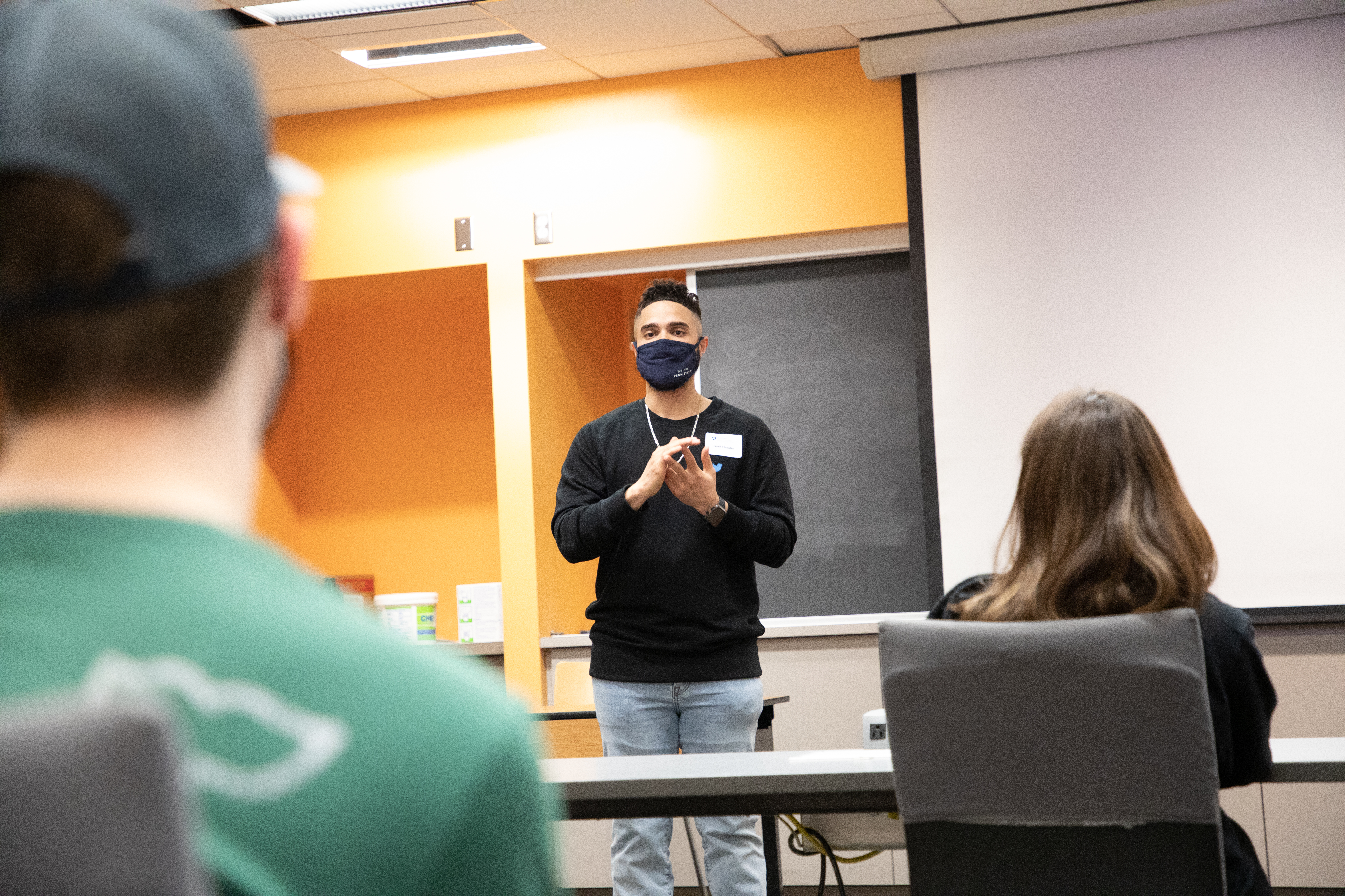 Noel Claudio speaks to a class of students.