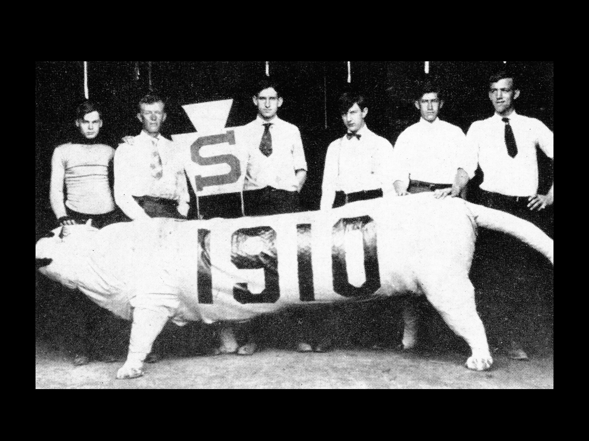 Six students posing with a papier-mache Nittany Lion in 1910 at Penn State