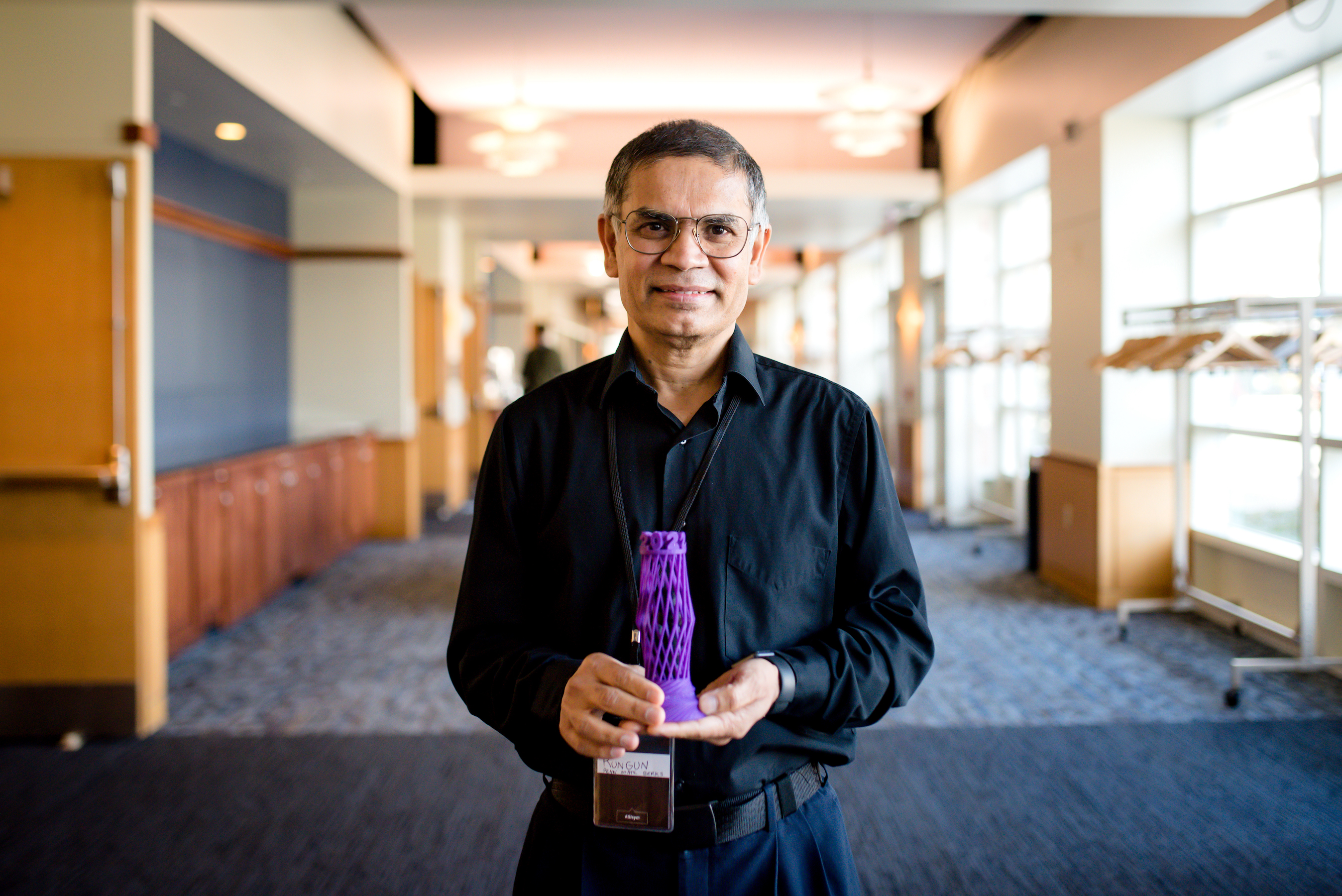 Rungun Nathan holds his award for winning the 2022 Open Innovation Challenge.