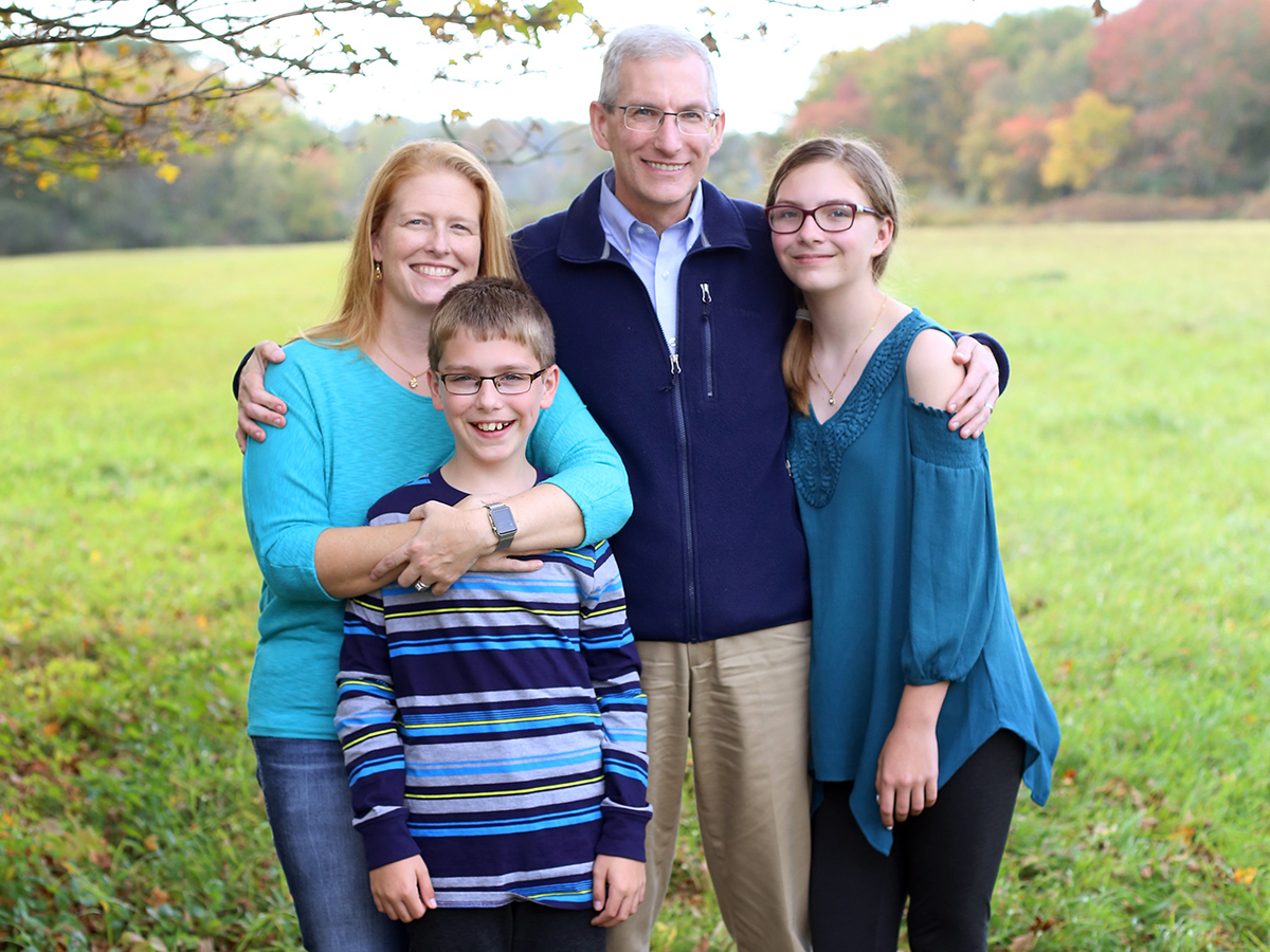 A photo of the Booth family standing in a grassy meadow.