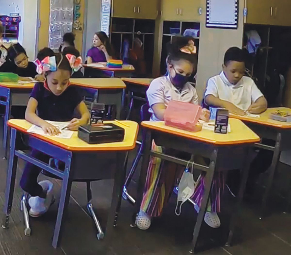 Elementary students sitting at desks in a classroom