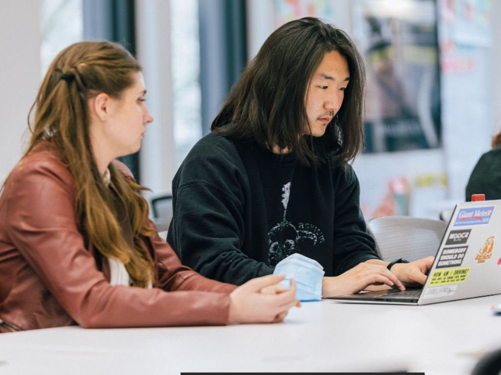 Two founders work together at a table