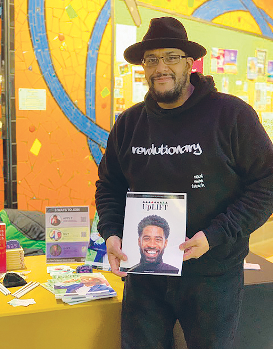 Jonathan C.W. Jones holding a copy of UpLIFT magazine