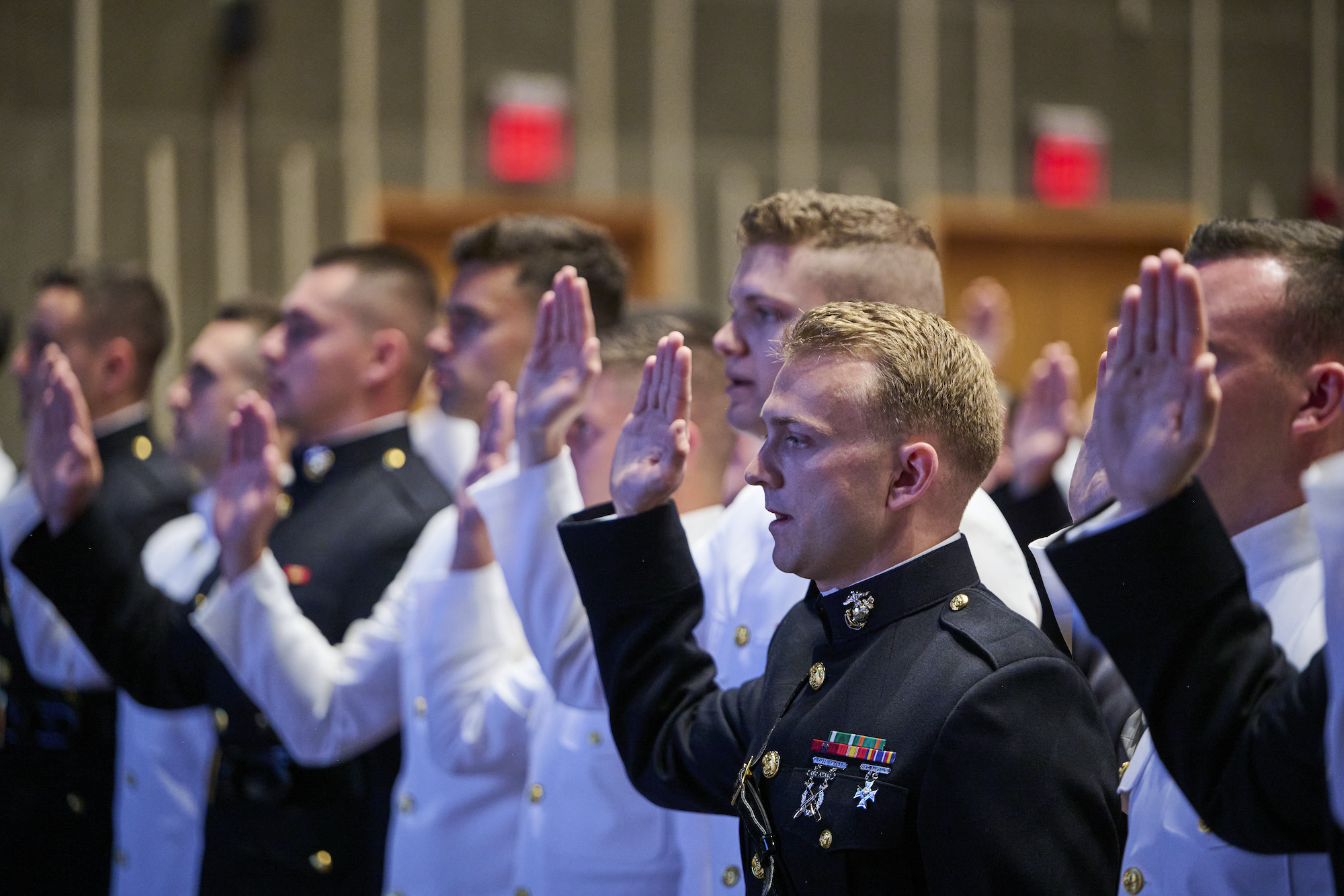 Naval ROTC cadets and midshipmen take oaths during commission ceremony