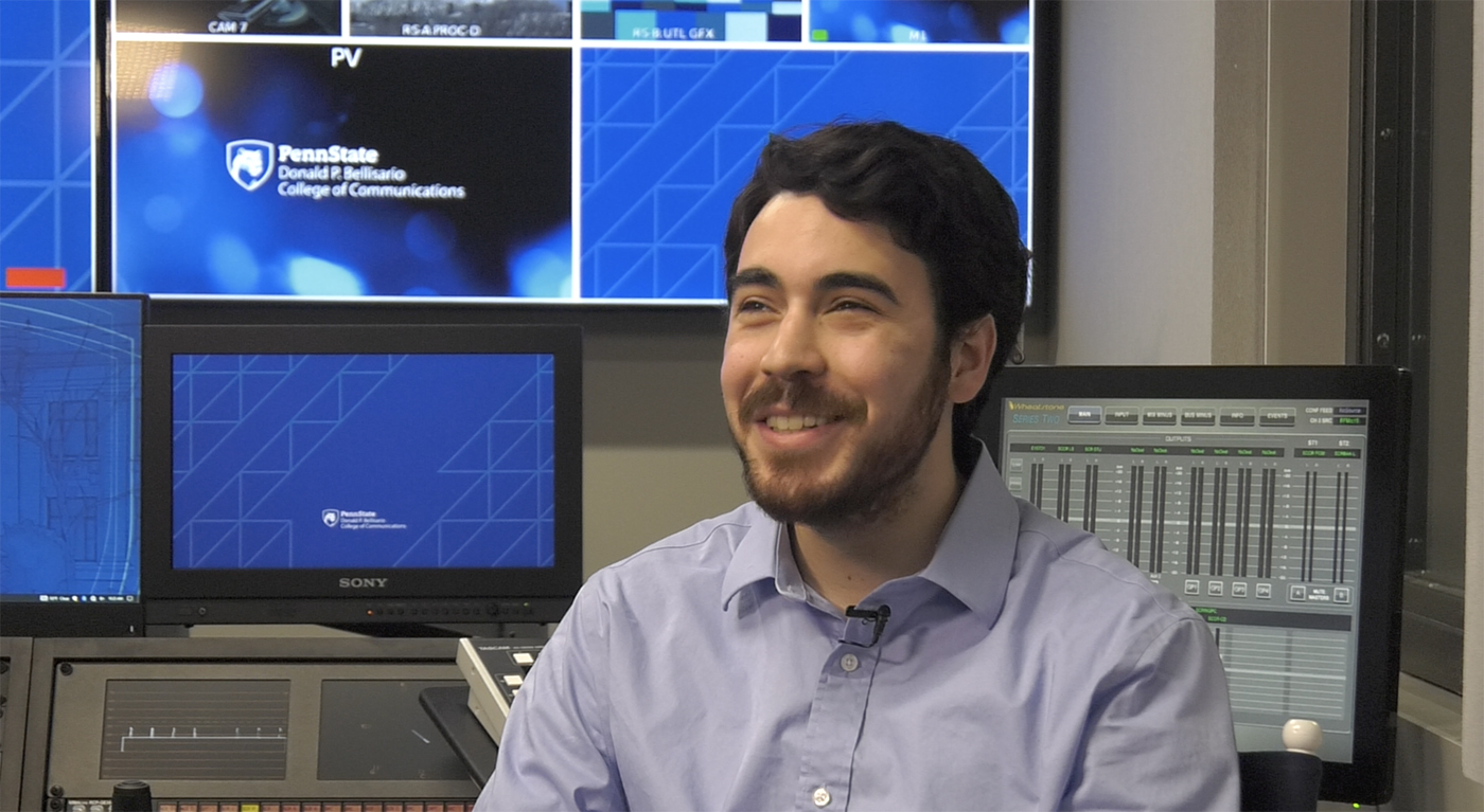 Michael Smedley smiling while seated in a in recording studio