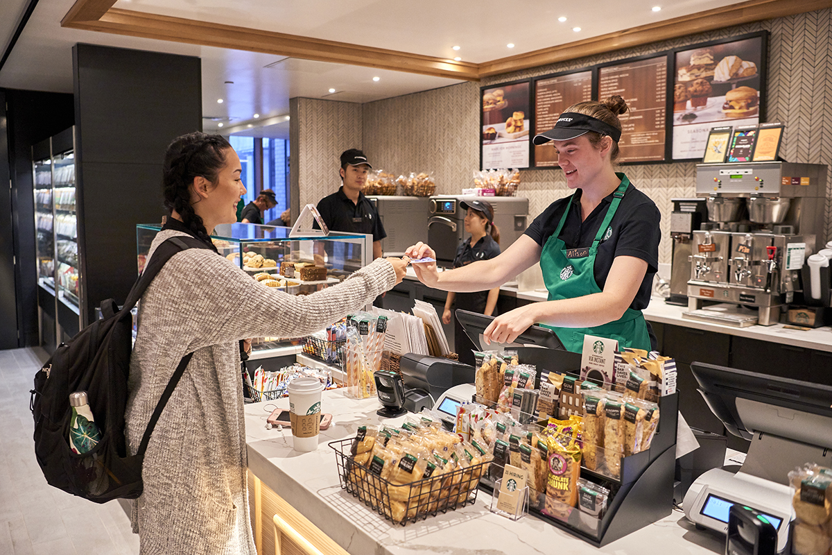 A student makes a purchase with her Penn State ID card at the Starbucks located in Pattee Library.