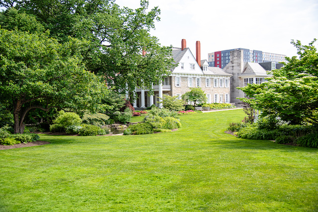 A building, lawn, and foliage