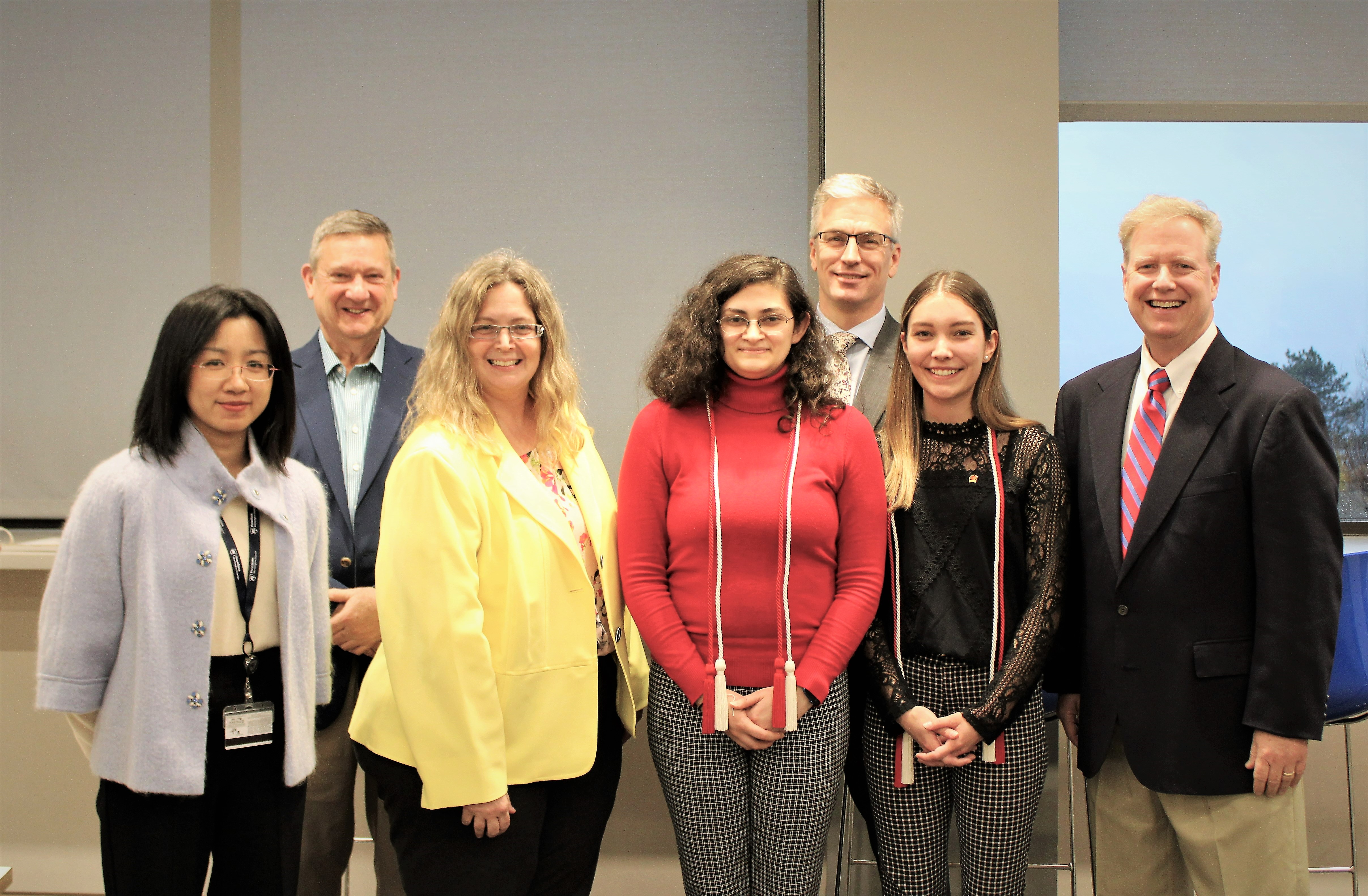 Lambda Pi Eta honor cord recipients pose with faculty members after cording ceremony