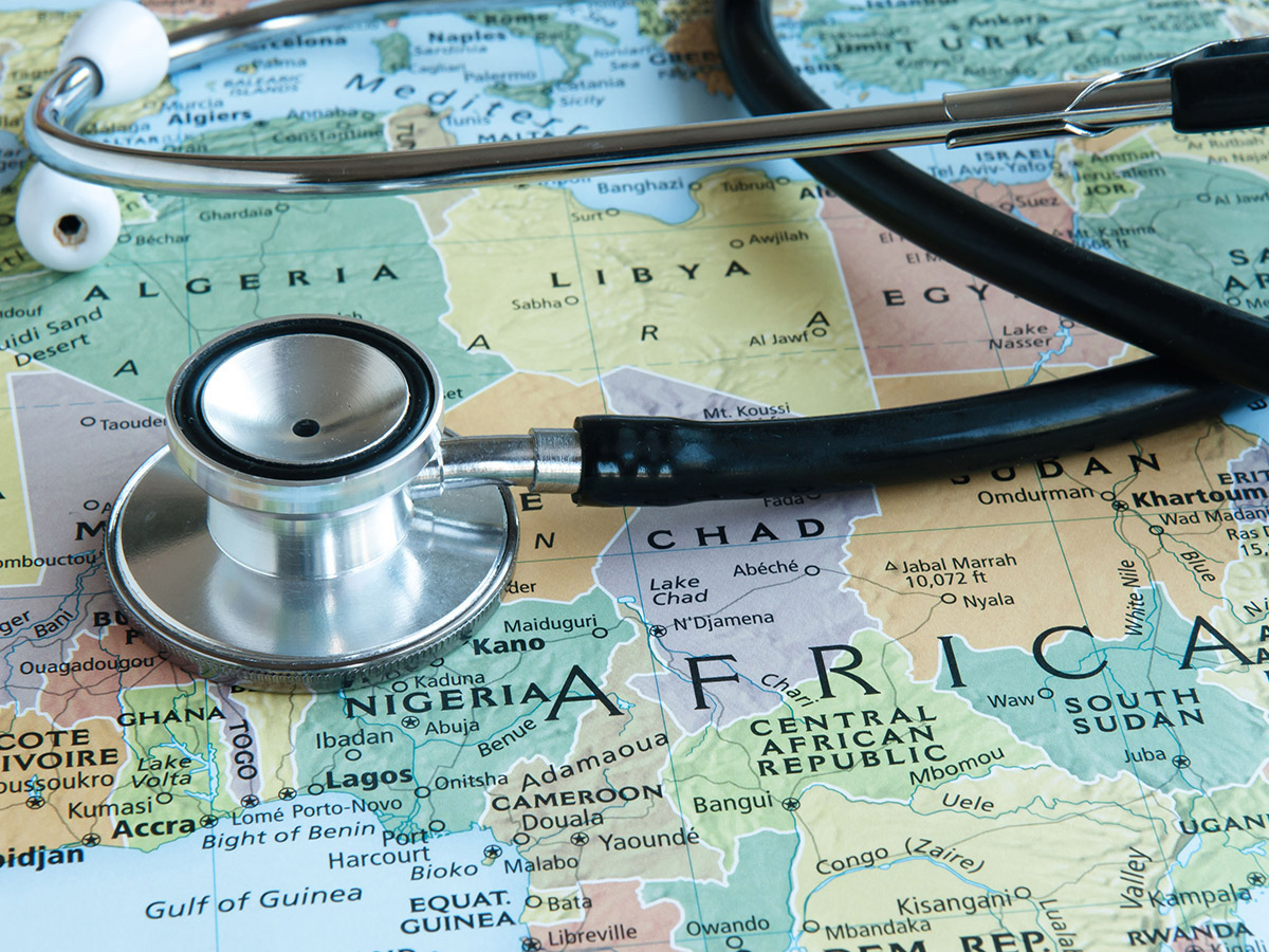 A stethoscope lays over a map of the continent of Africa.