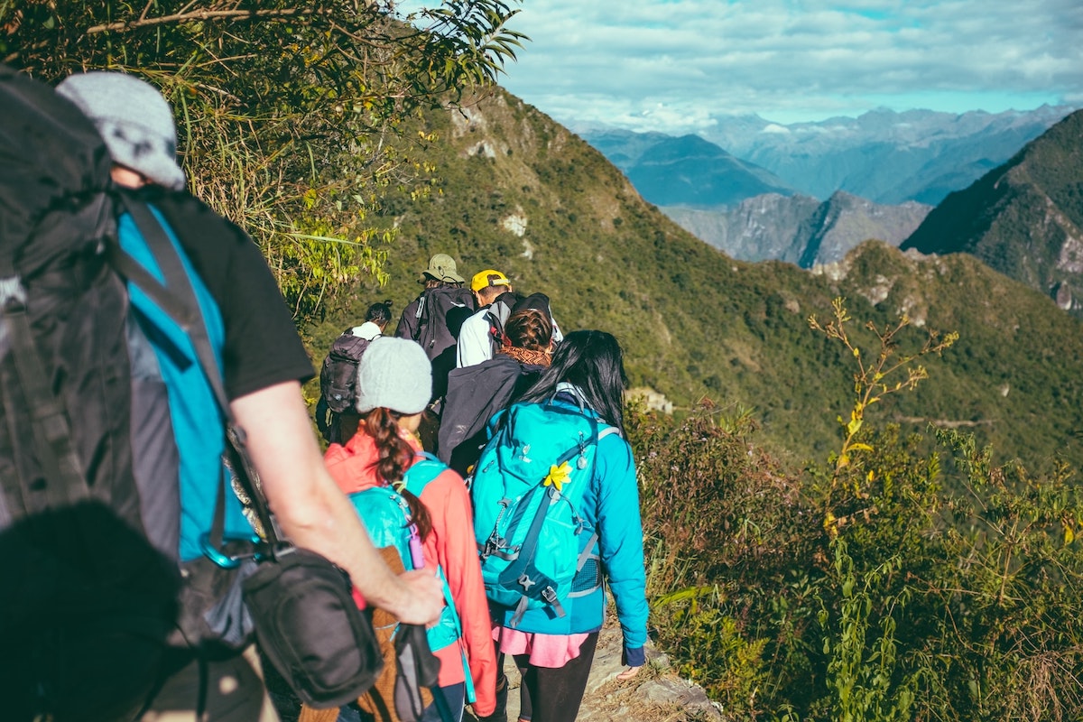 Large group hiking in a mountainous landscape. 