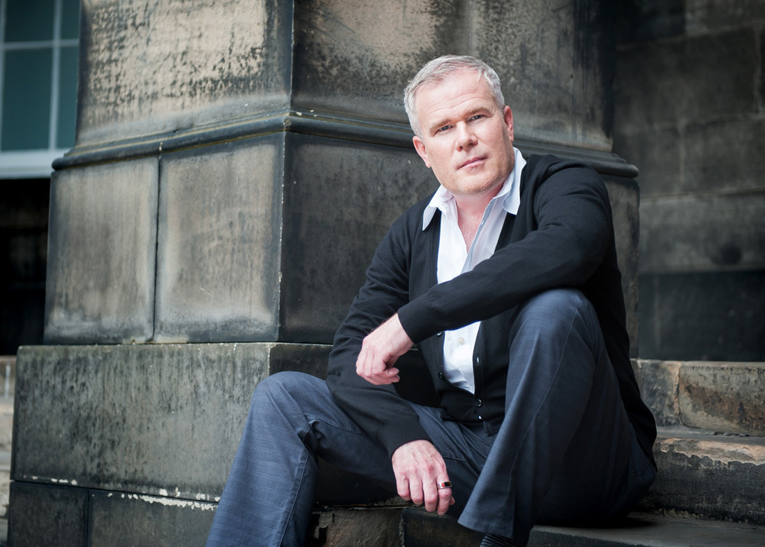 Photograph of Paul Daniel Marriott sitting on steps of a building.