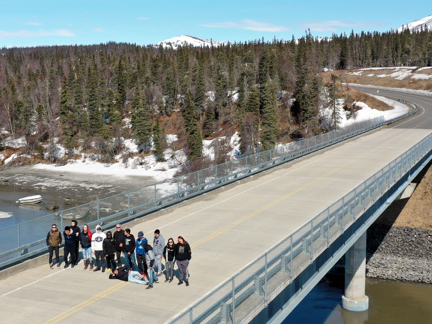 aerial drone image of students standing on bridge in Alaska