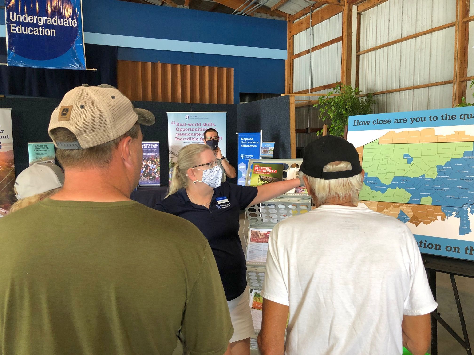 Ag Progress Days visitors look at a map of spotted lanternfly spread in Pennsylvania in 2021