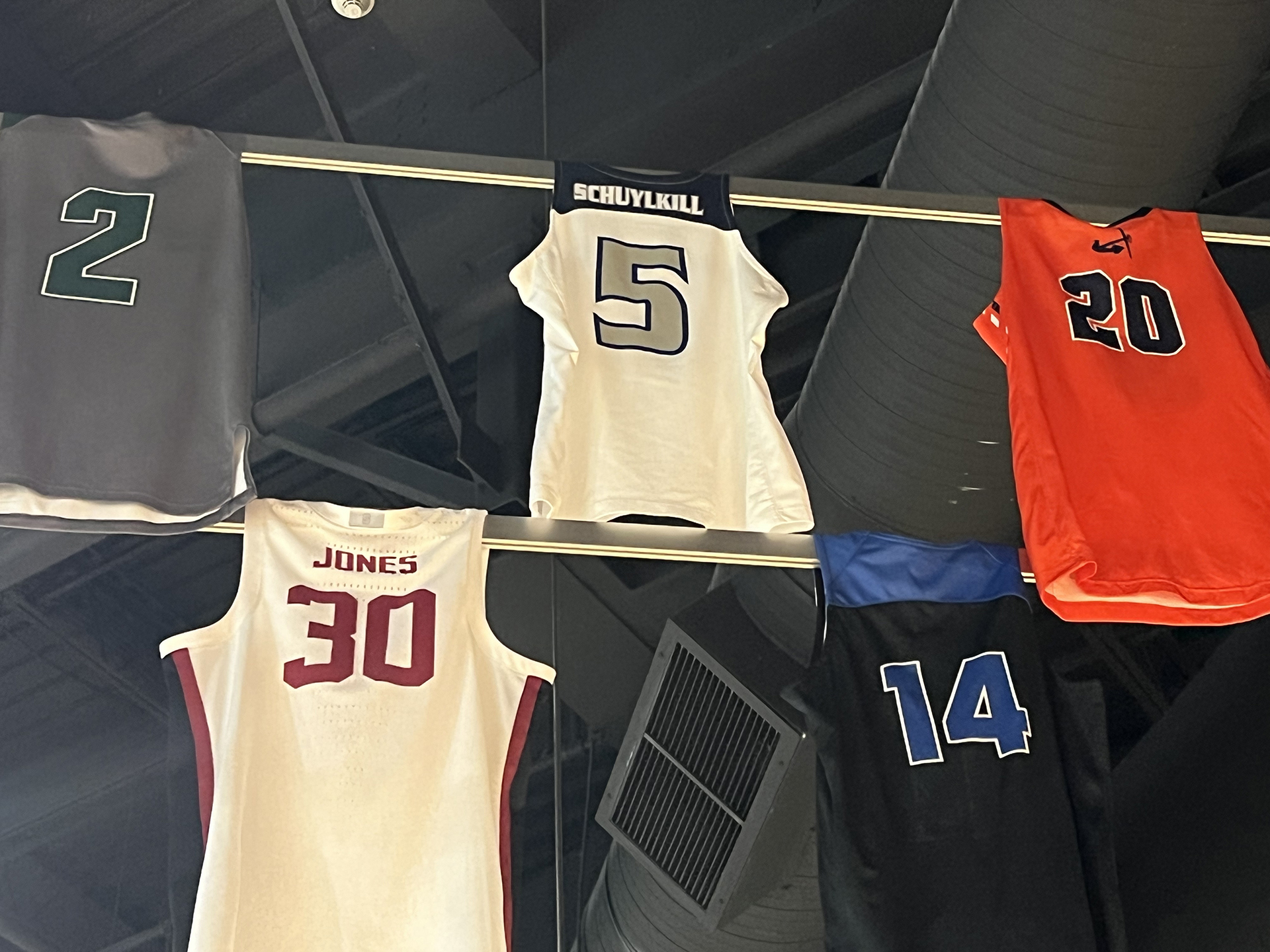 Basketball jerseys hanging form rafters in Hall of Fame