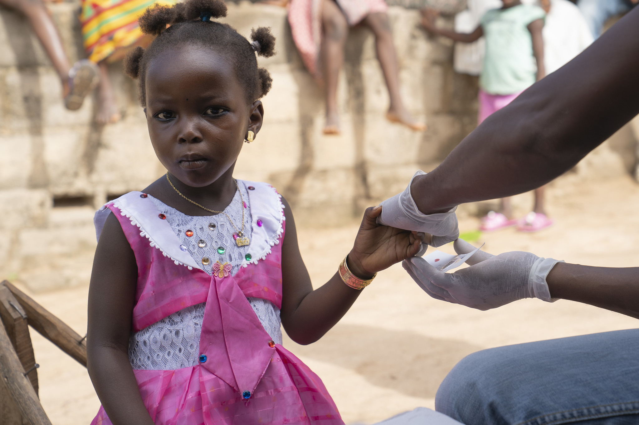 Girl receiving malaria test