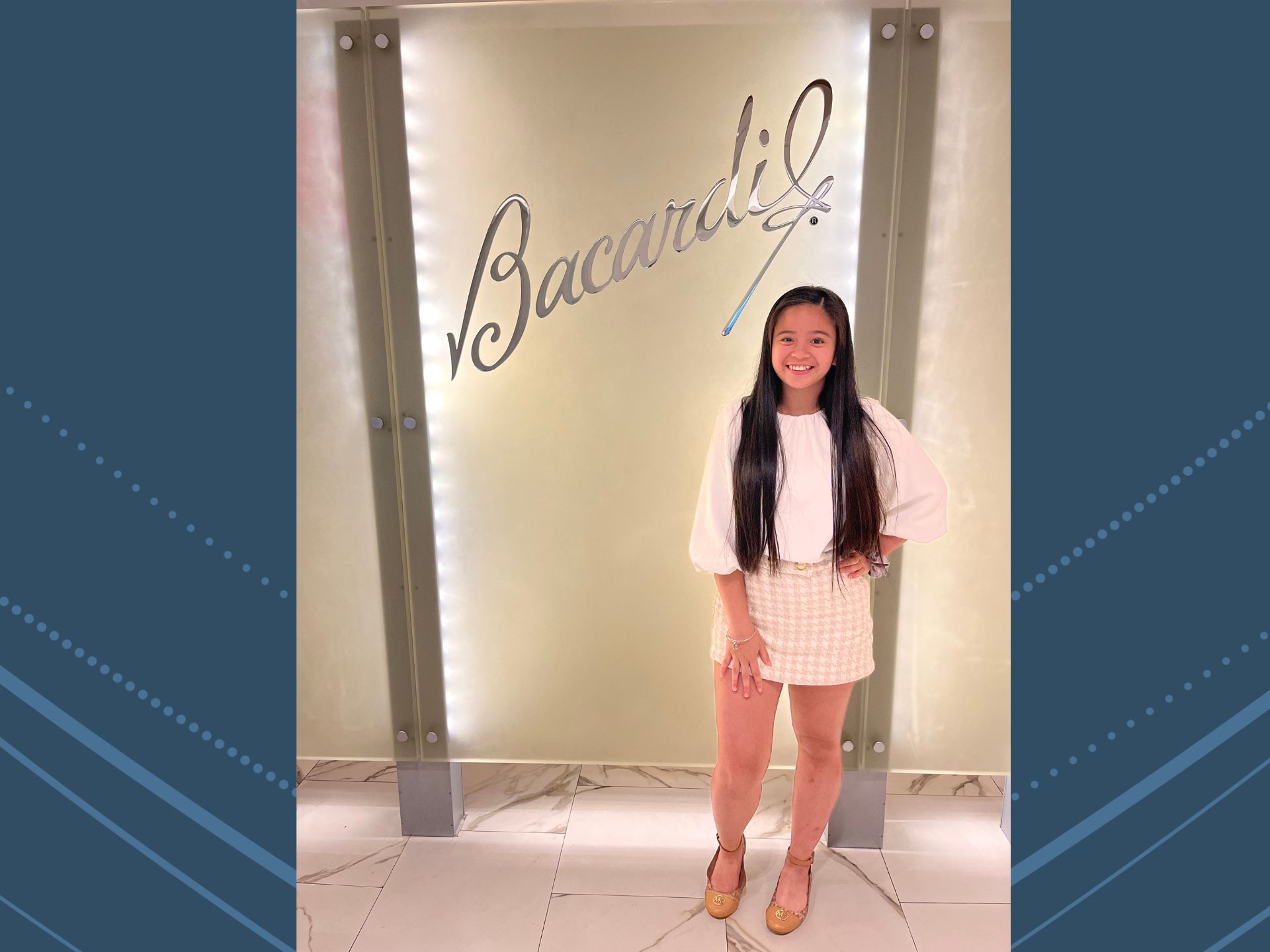 Ella Maquito stands in front of the Bacardi sign during her summer internship with the company