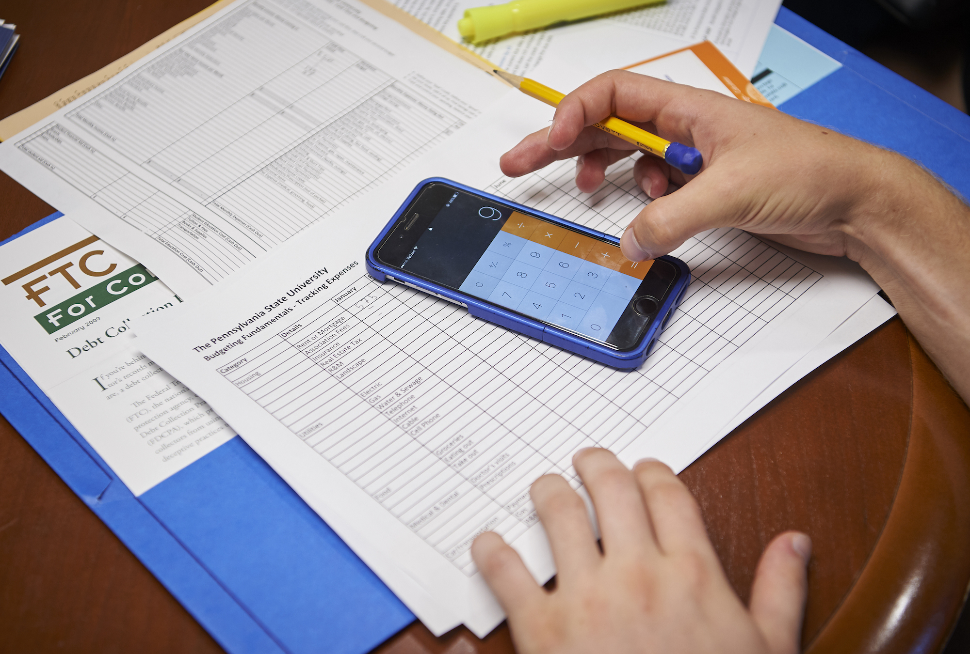 Person creating budget using paper and calculator