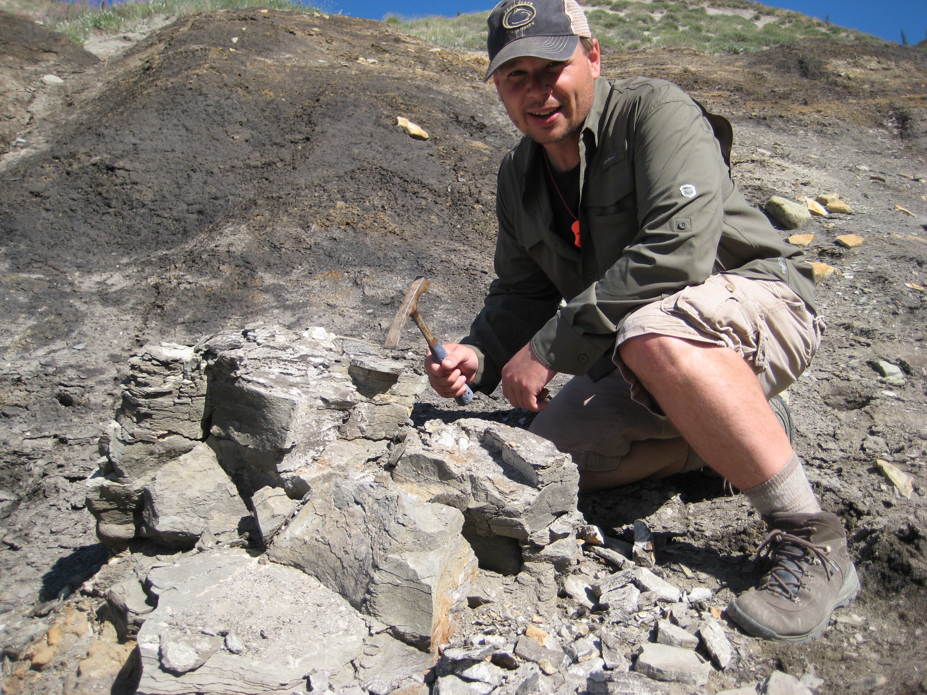 Todd Cook using a tool to dig for fossils.