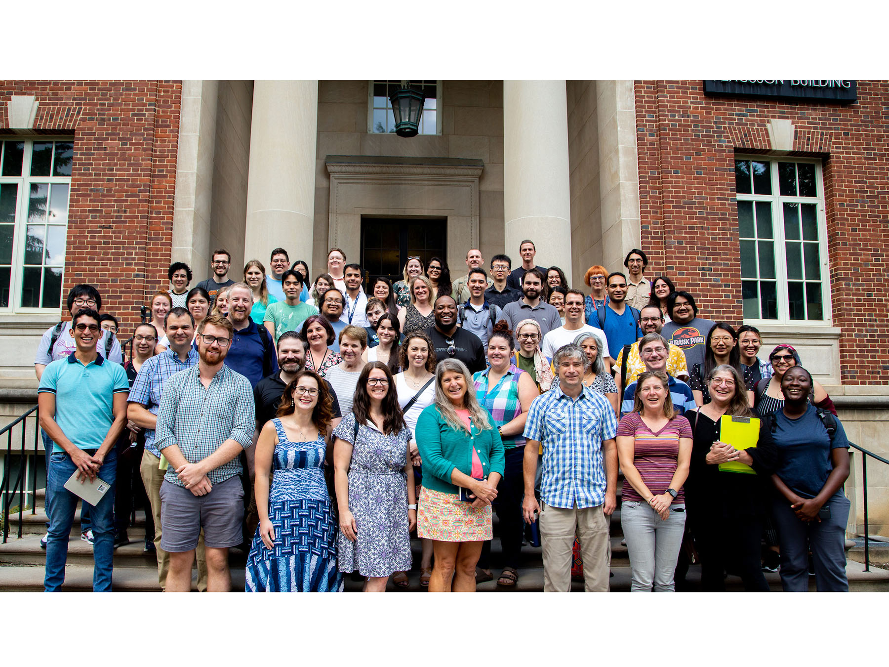 The Microbiome Center team lined up in multiple rows smiling and looking at the camera